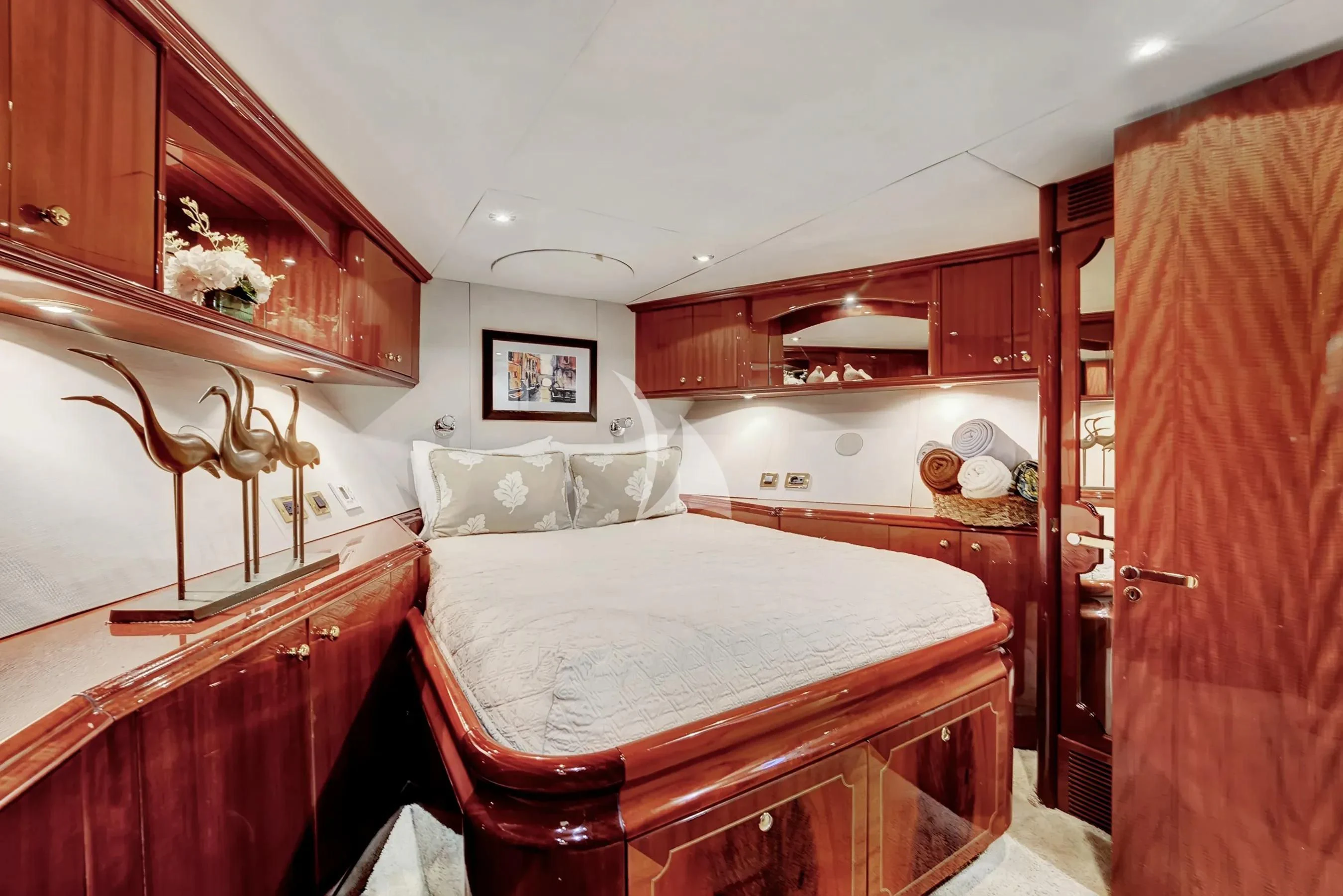 a bedroom with a bed and a dresser aboard LE REVE Yacht for Sale