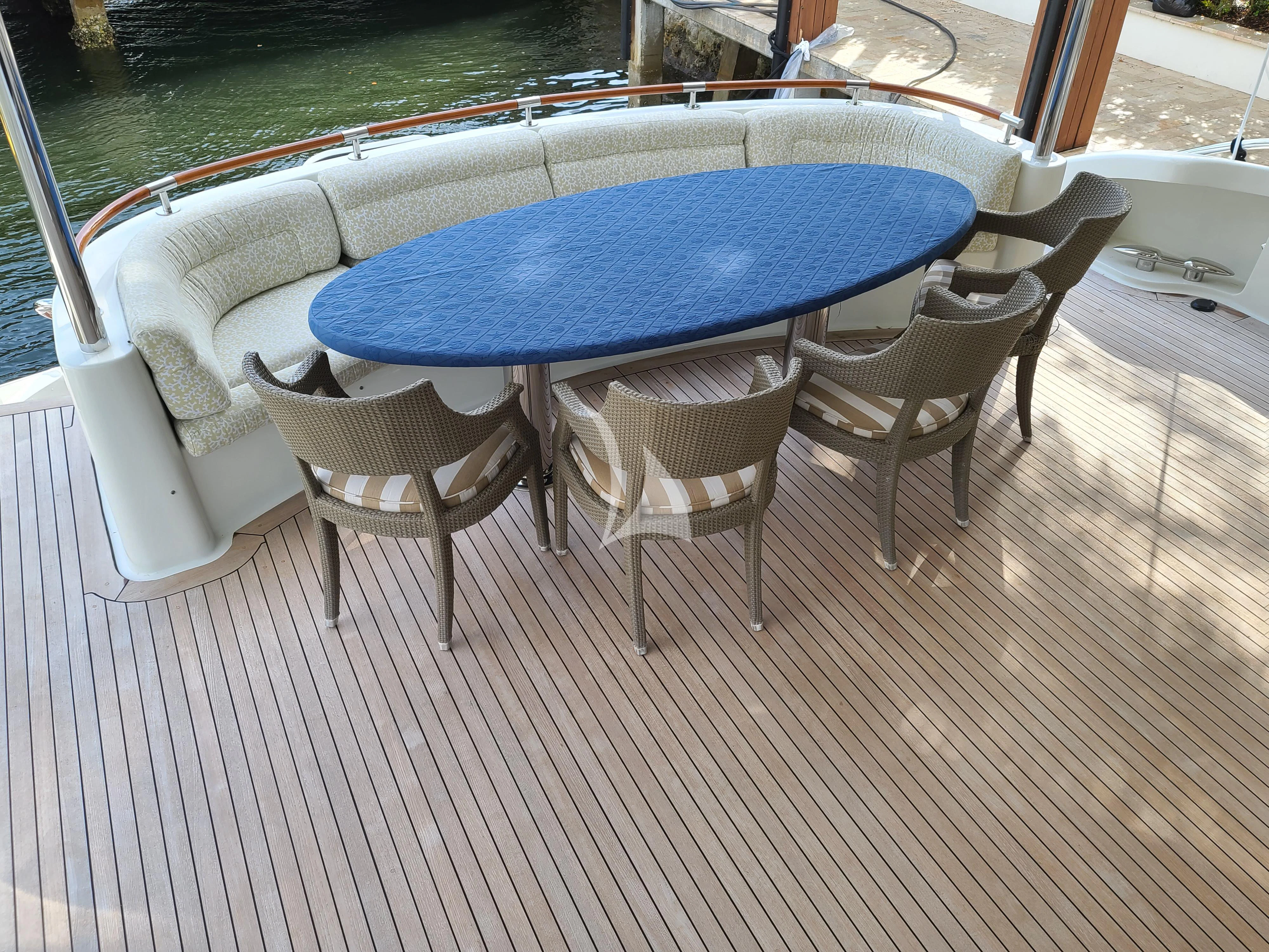 a table and chairs on a deck aboard LE REVE Yacht for Sale