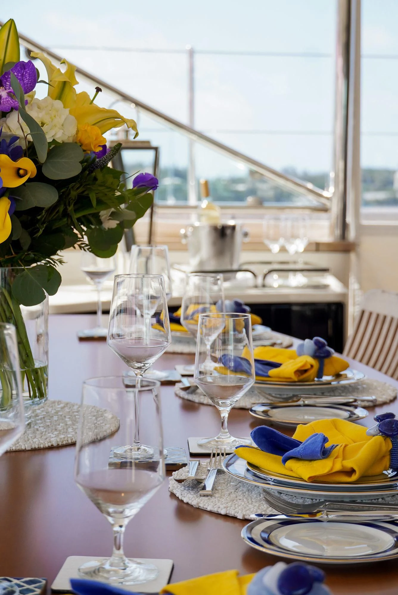 a table with plates and glasses aboard ZENJI Yacht for Sale