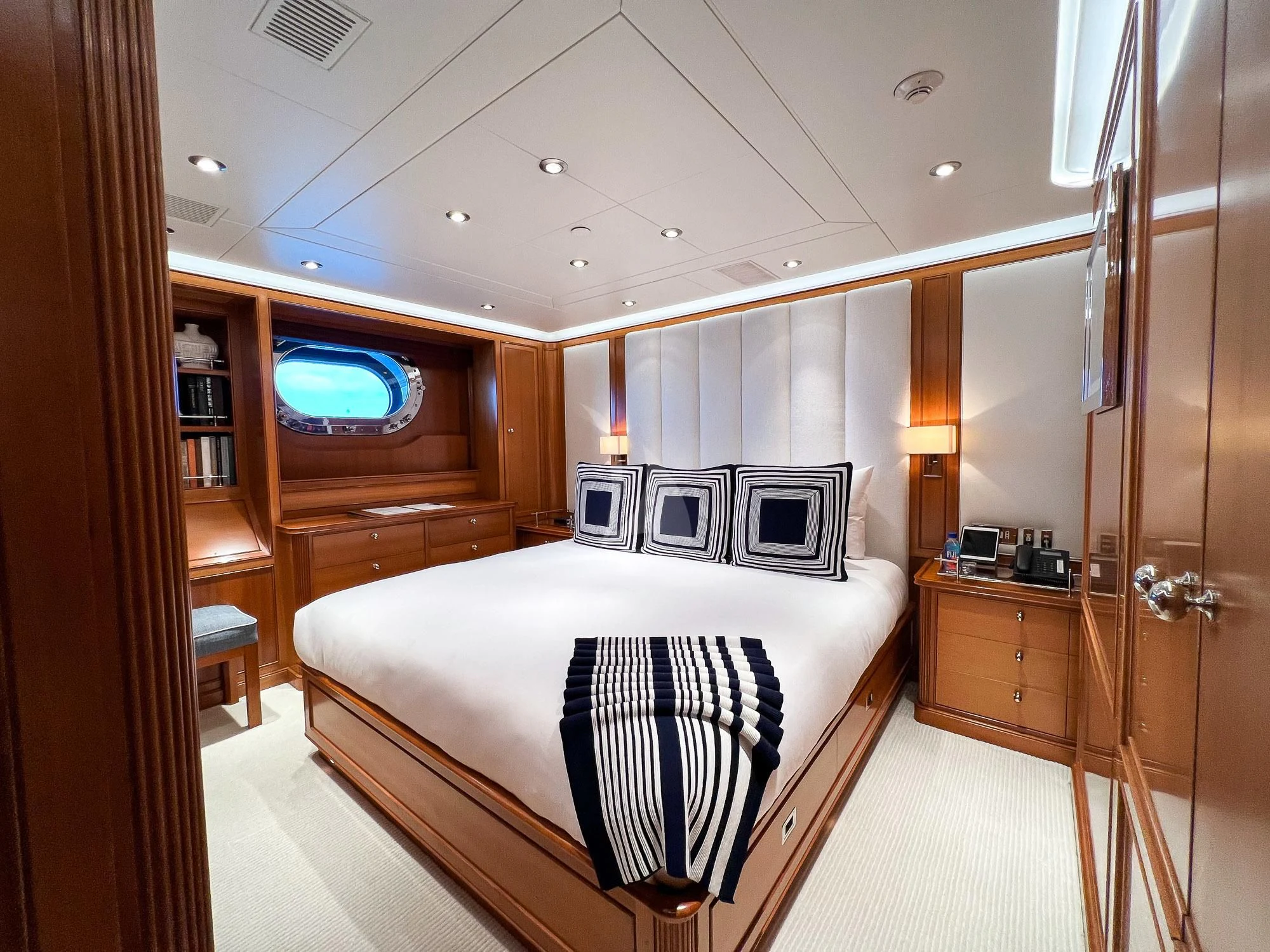 a bedroom with a bed and a closet aboard ZENJI Yacht for Sale