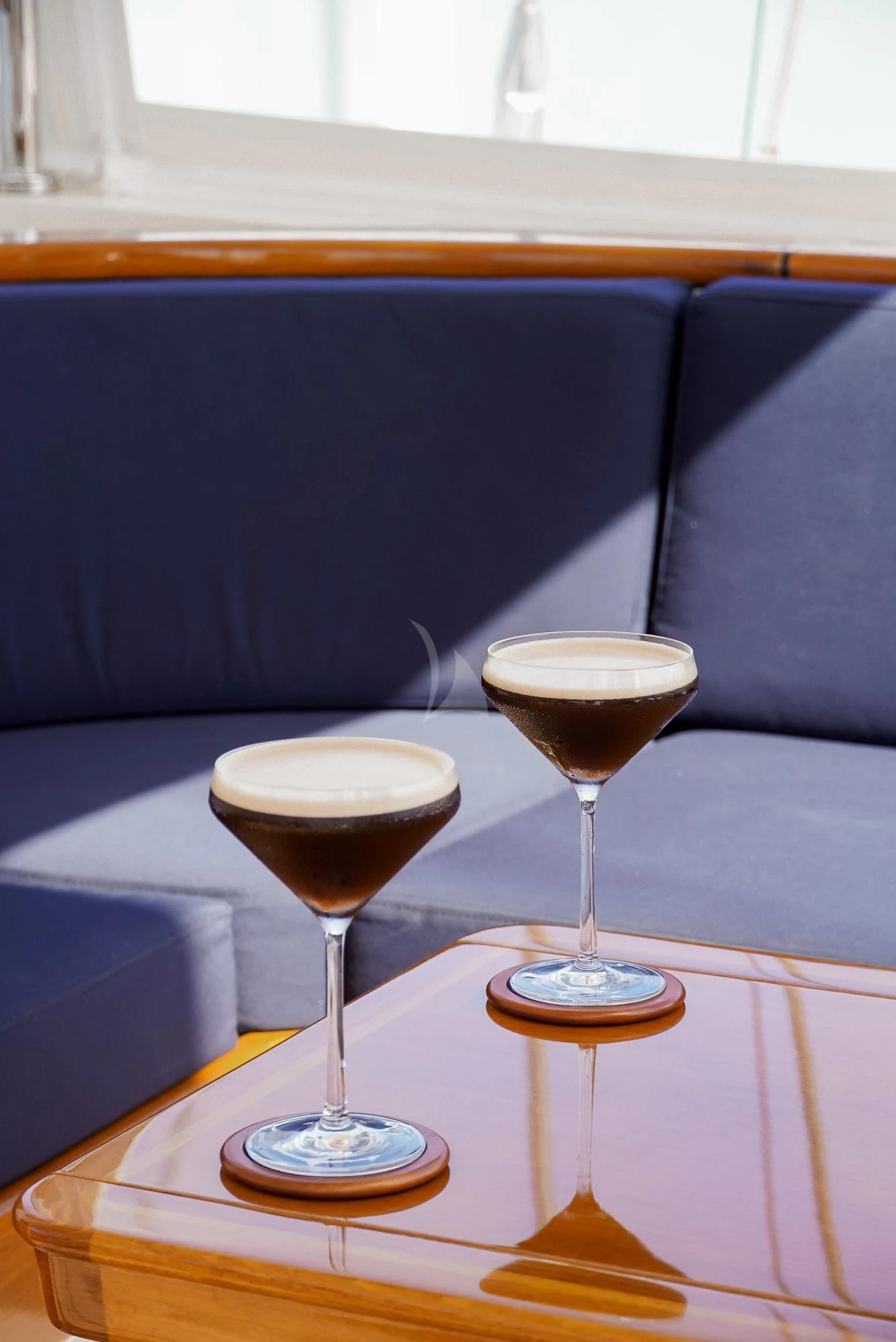 glasses of brown liquid on a table aboard ZENJI Yacht for Sale