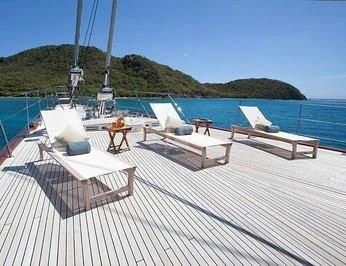 a deck with lounge chairs on it aboard ZENJI Yacht for Sale
