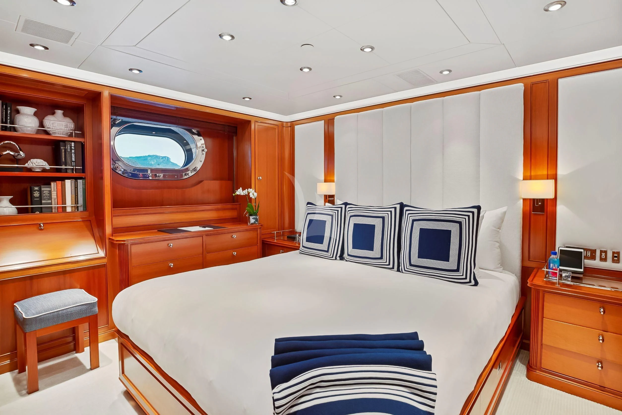 a bedroom with a bed and a bookcase aboard ZENJI Yacht for Sale