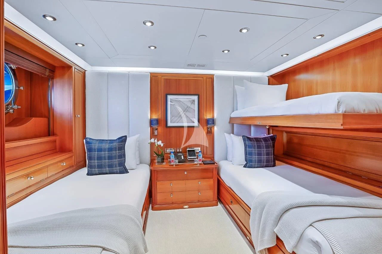 a room with beds and a mirror aboard ZENJI Yacht for Sale
