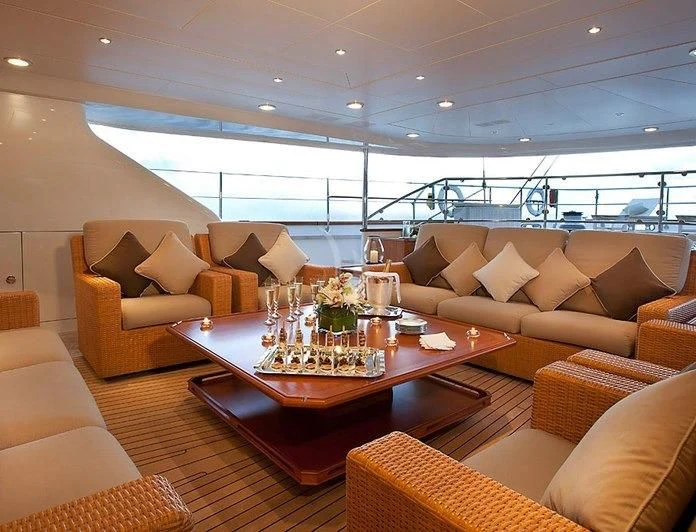 a living room with a table and chairs aboard ZENJI Yacht for Sale