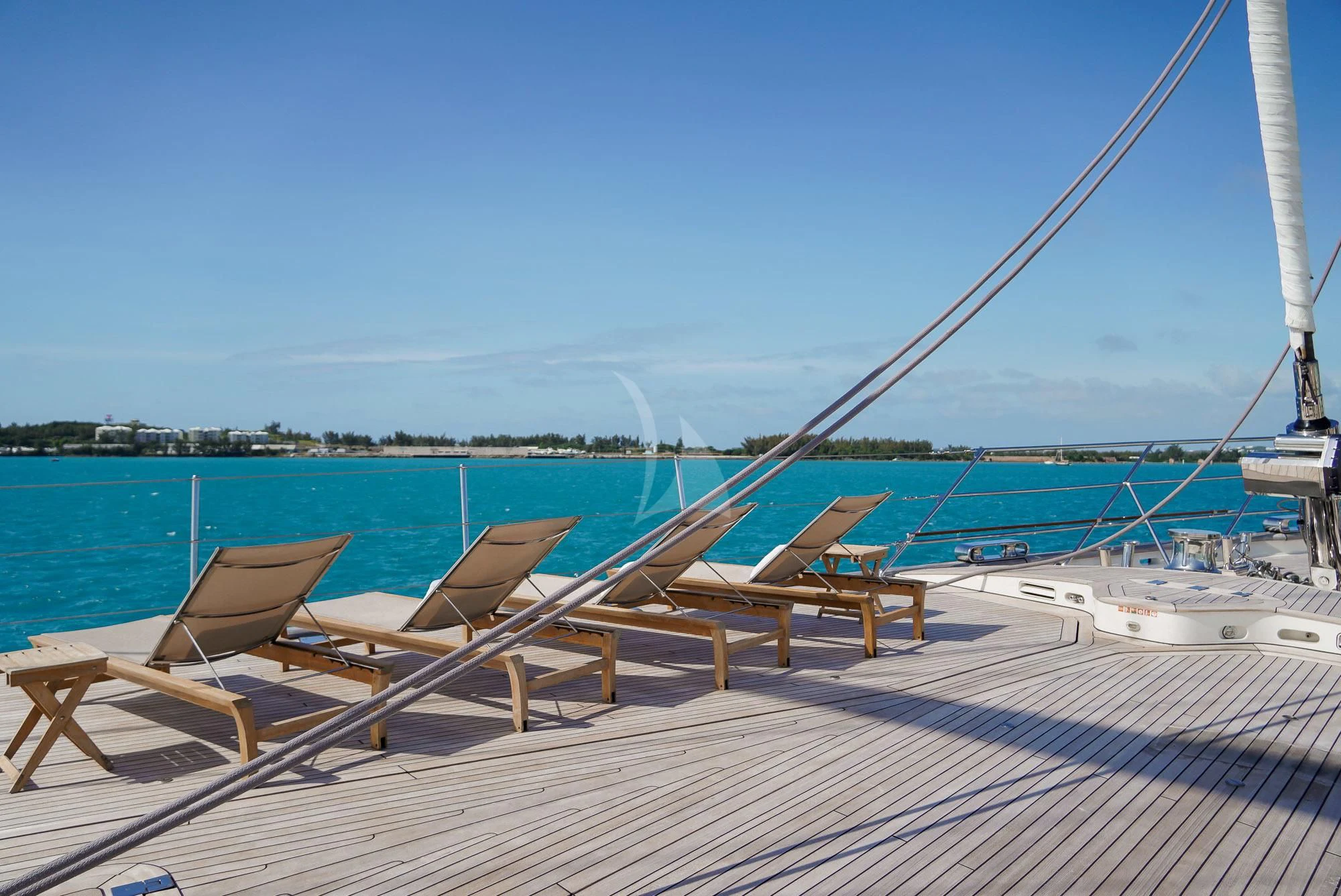 a deck with chairs and a railing overlooking a body of water aboard ZENJI Yacht for Sale