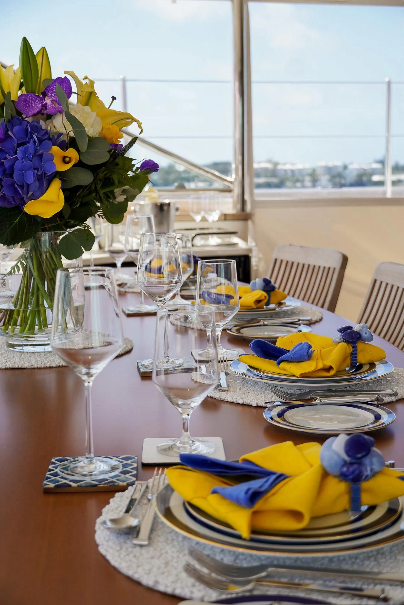 a table with plates and glasses aboard ZENJI Yacht for Sale