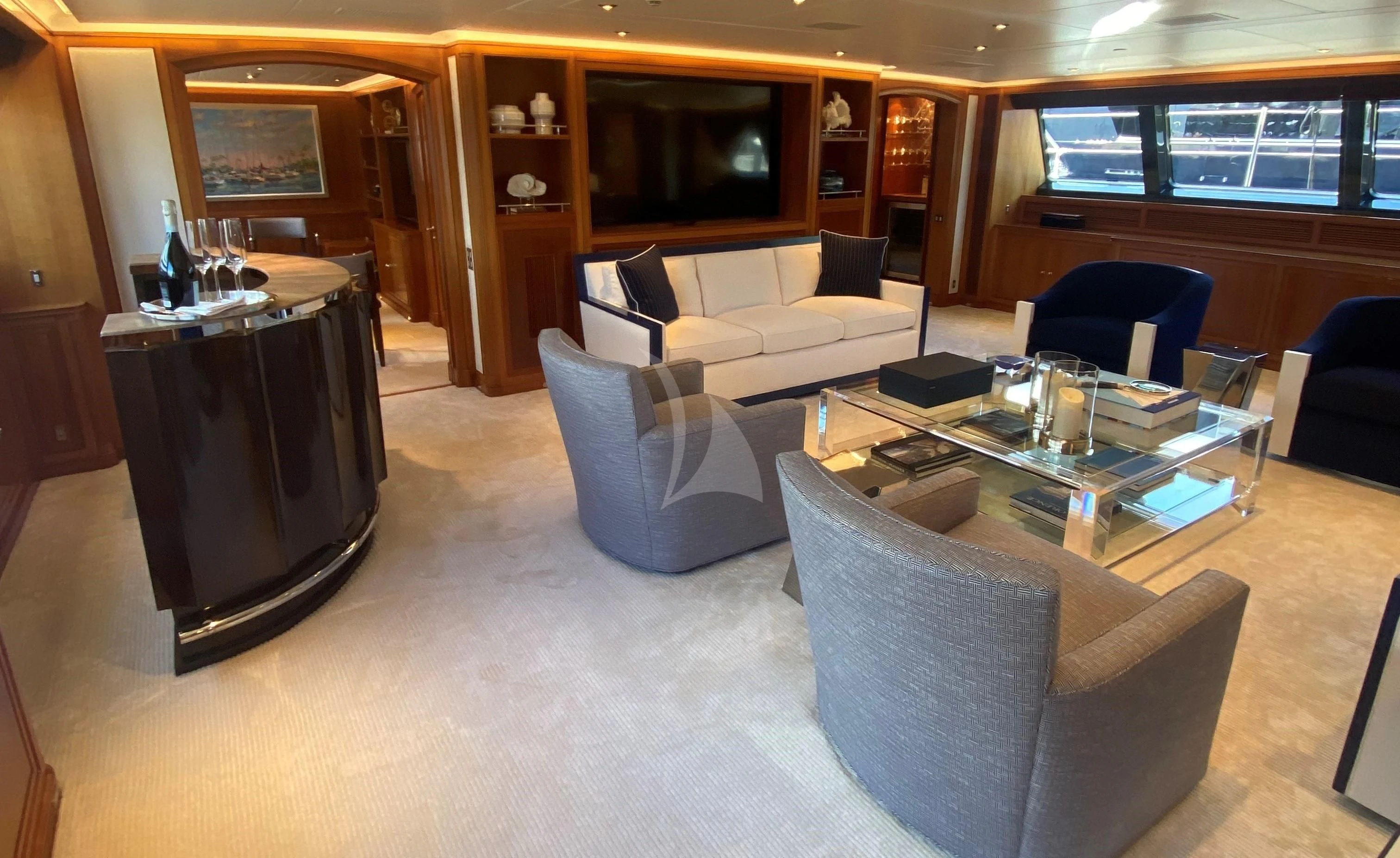 a living room with a tv and a table aboard ZENJI Yacht for Sale