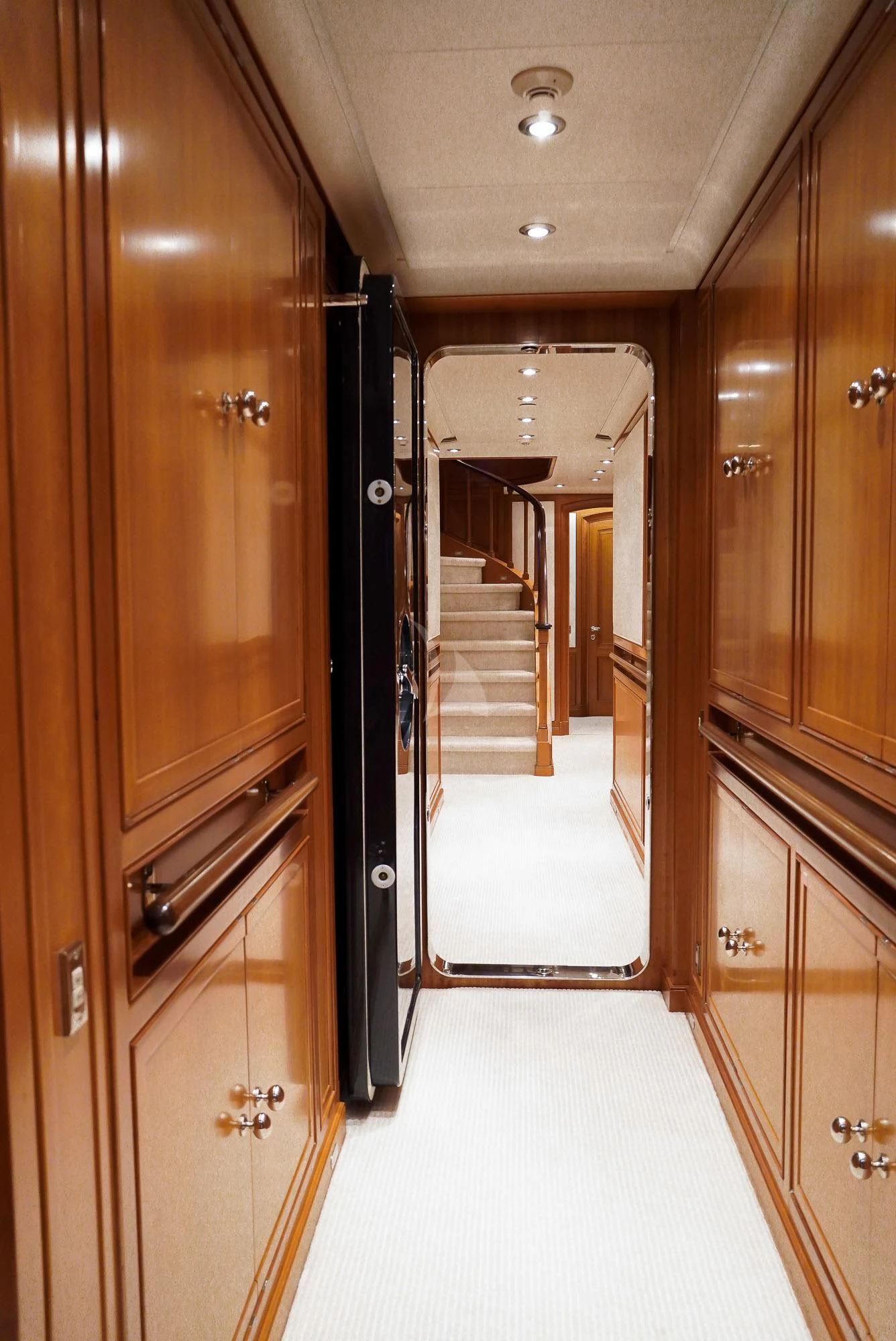 a hallway with wooden cabinets aboard ZENJI Yacht for Sale