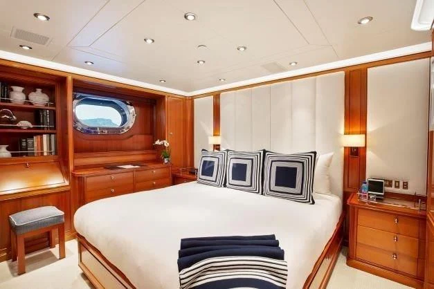 a bedroom with a bed and a desk aboard ZENJI Yacht for Sale
