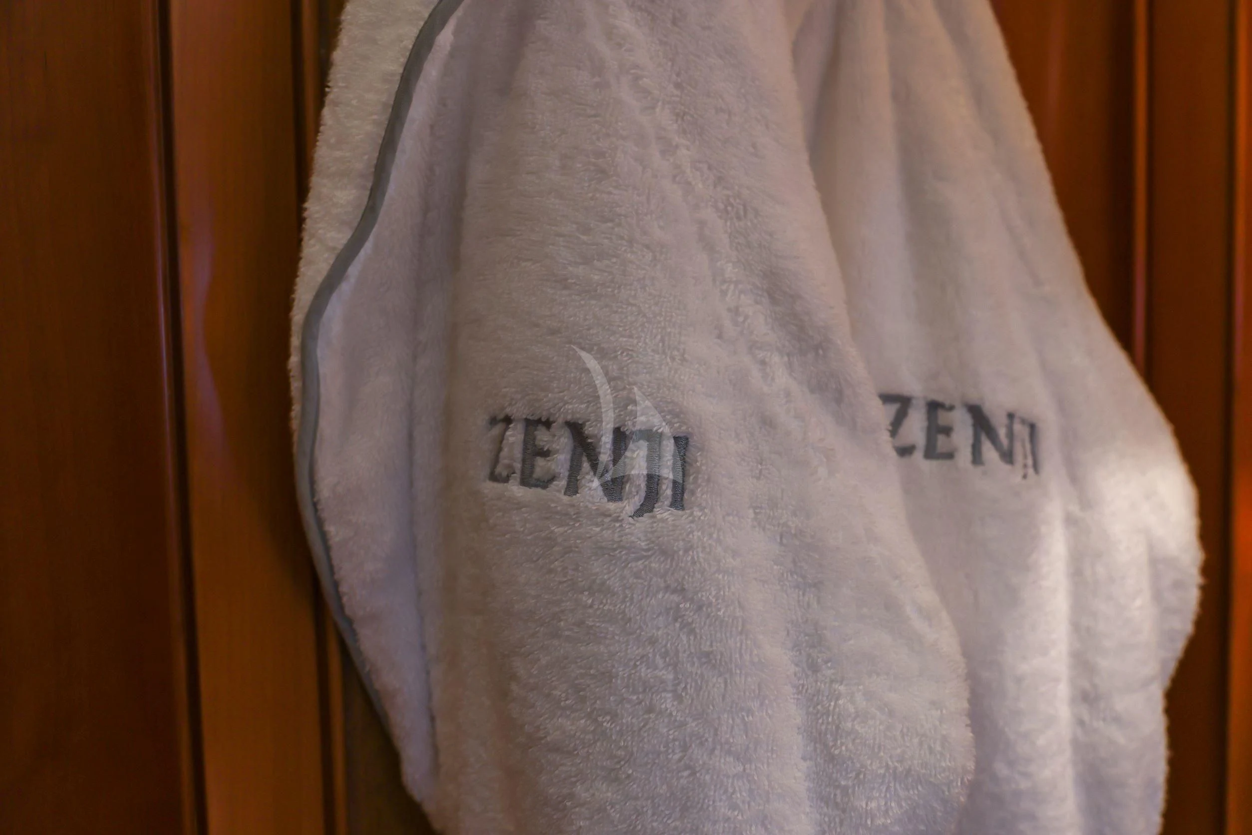 a person wearing a white shirt with a blue logo on it aboard ZENJI Yacht for Sale