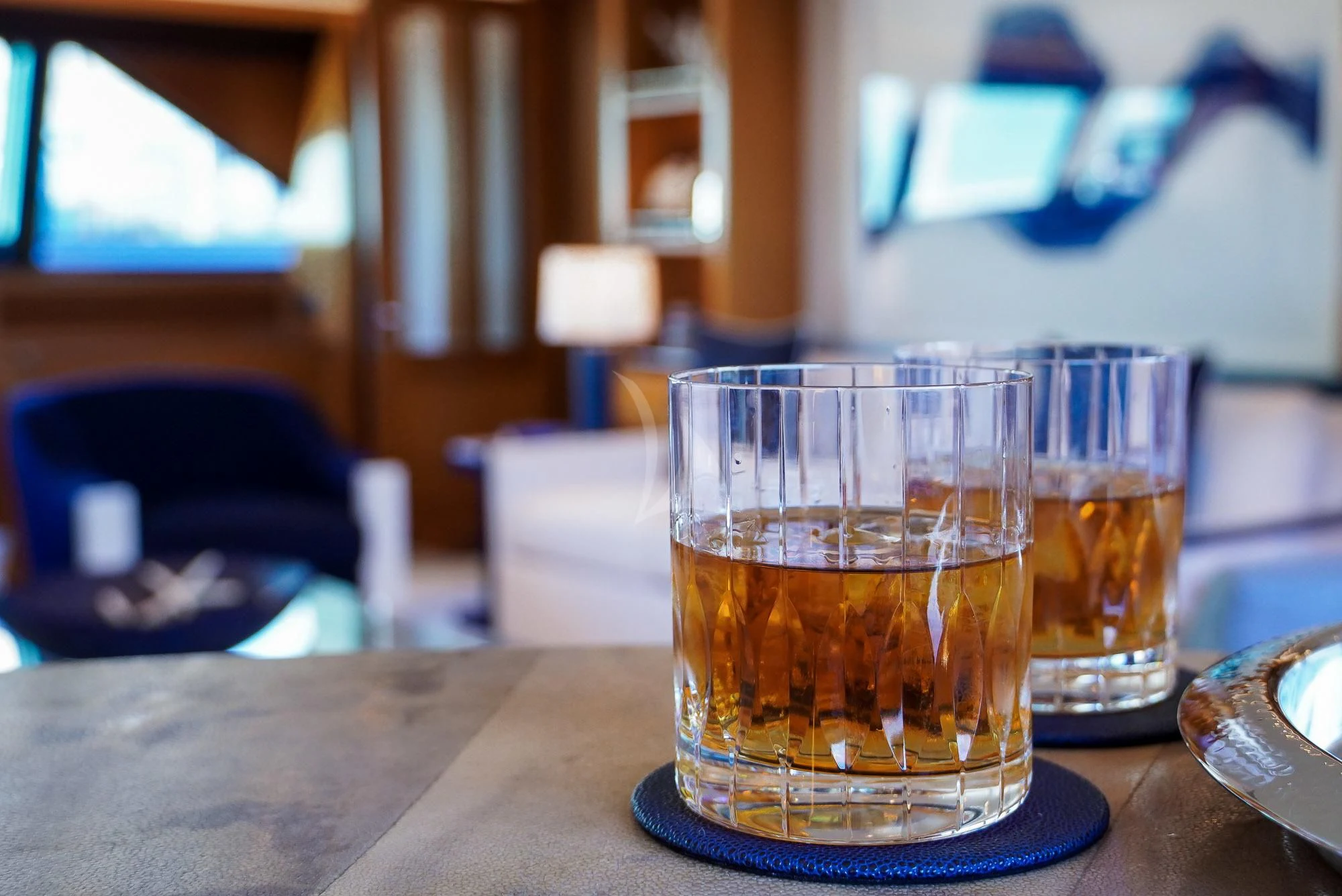 a couple of glasses of beer on a table aboard ZENJI Yacht for Sale