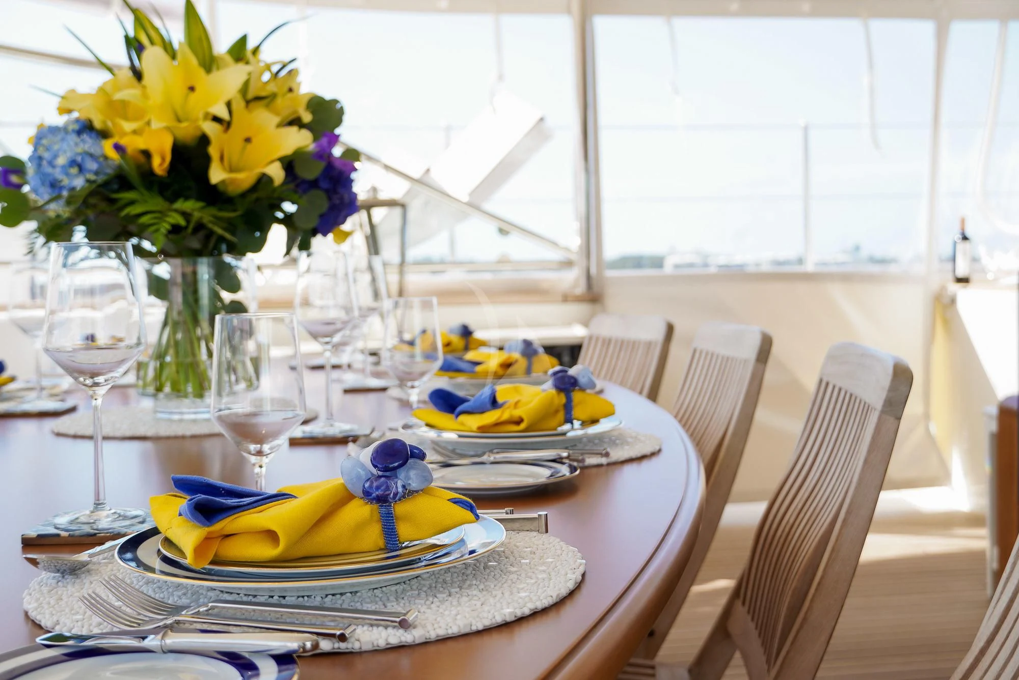 a table with plates and glasses aboard ZENJI Yacht for Sale