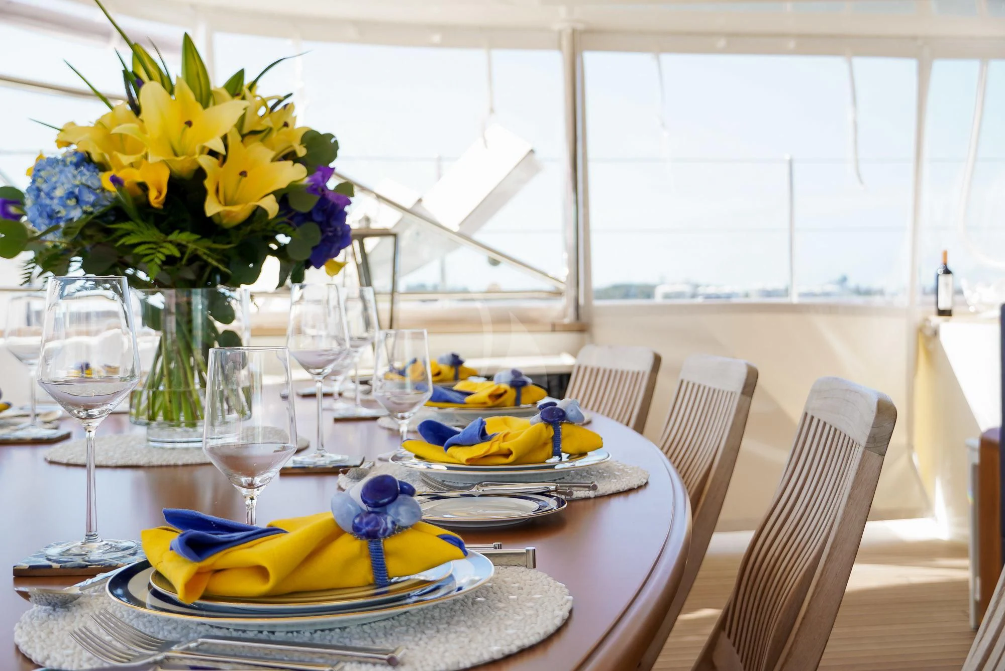 a table with plates and glasses aboard ZENJI Yacht for Sale