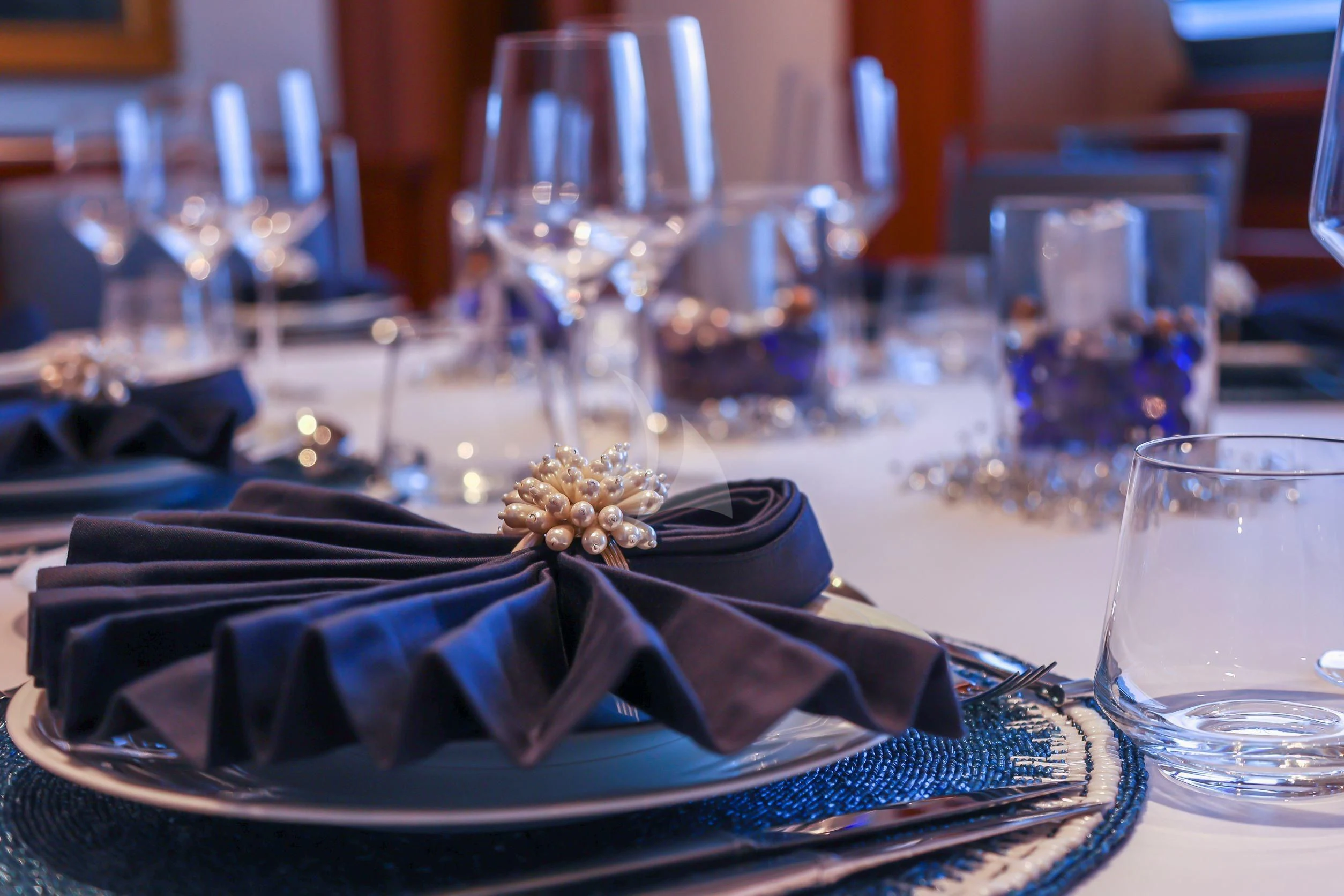 a gold crown on a plate aboard ZENJI Yacht for Sale