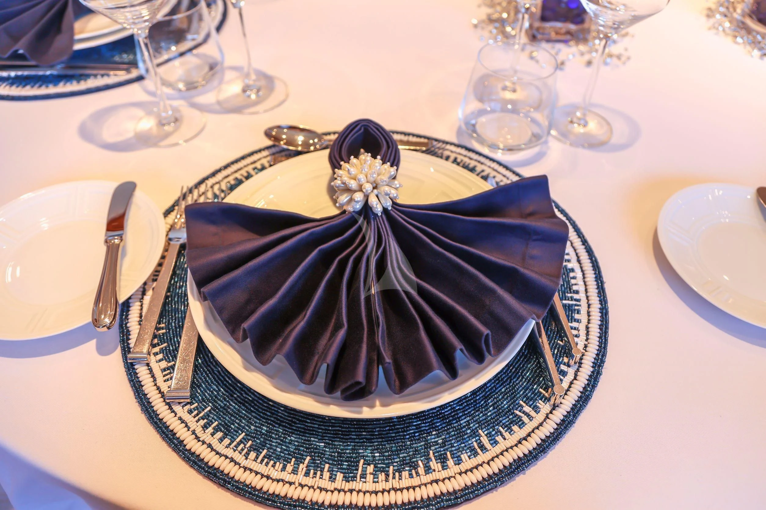 a black and white cake on a plate with silverware and silverware aboard ZENJI Yacht for Sale