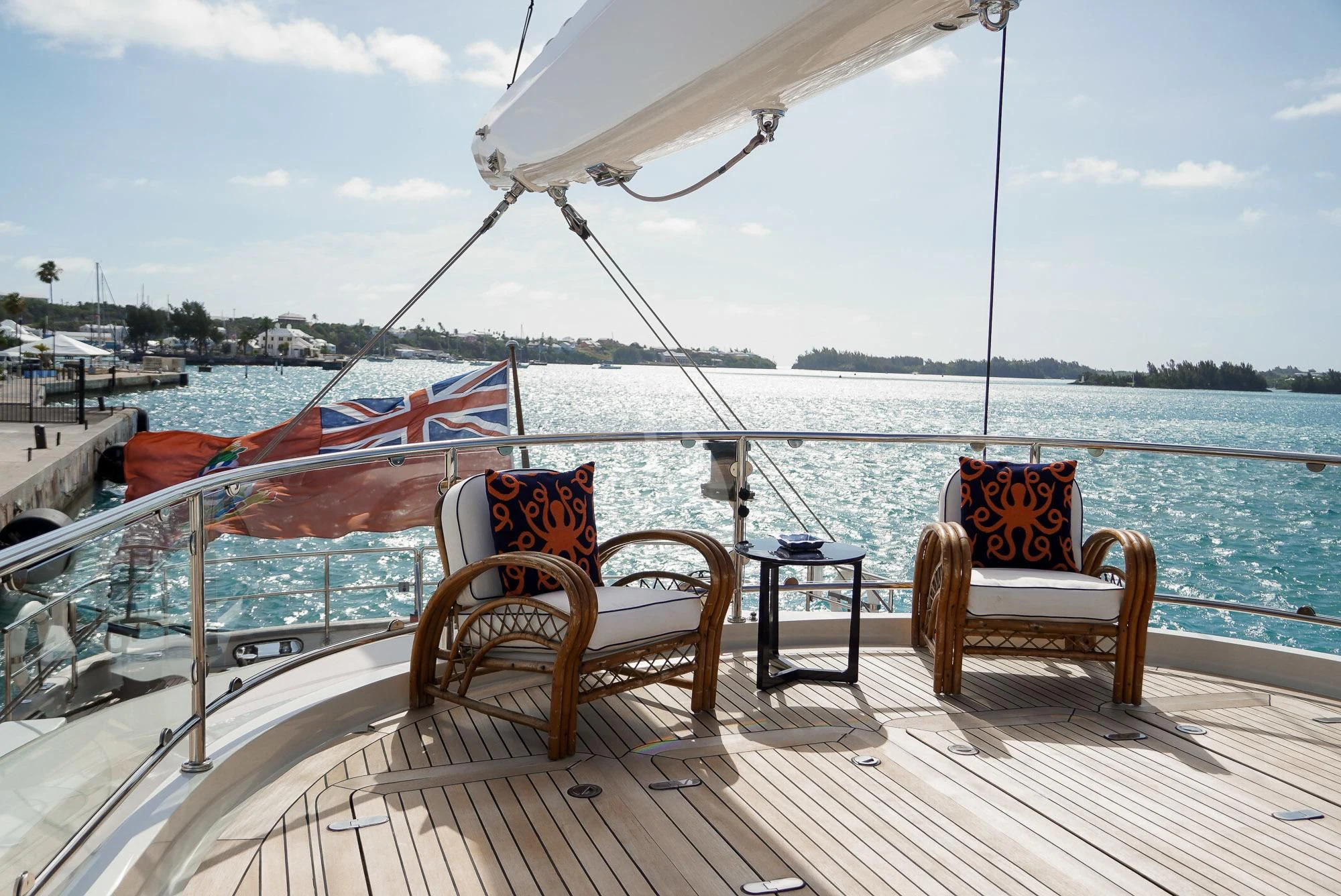 a couple chairs on a deck overlooking a body of water aboard ZENJI Yacht for Sale