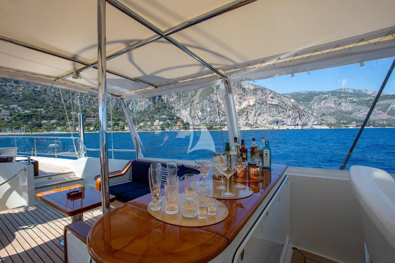 a table with glasses and bottles on it on a boat aboard ZENJI Yacht for Sale