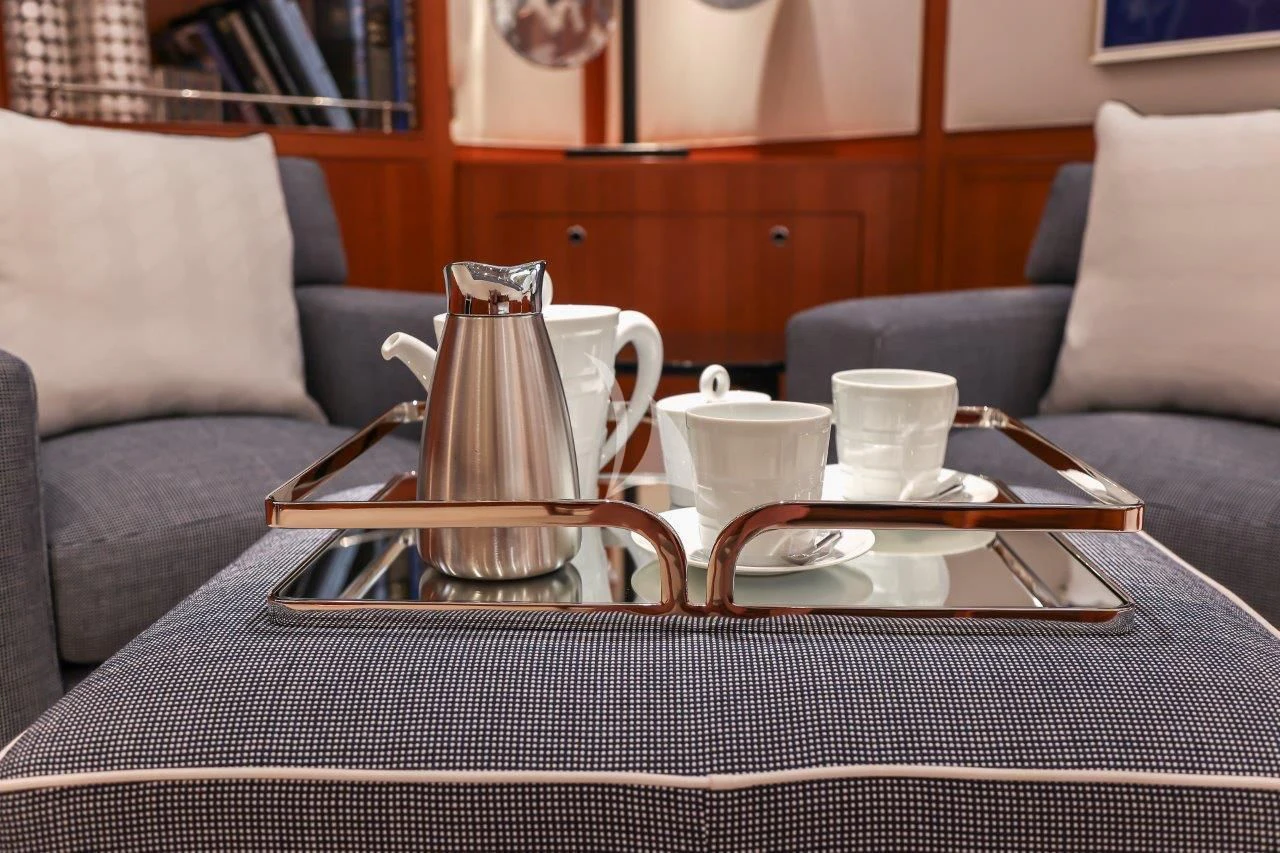 a coffee table with a glass on it aboard ZENJI Yacht for Sale