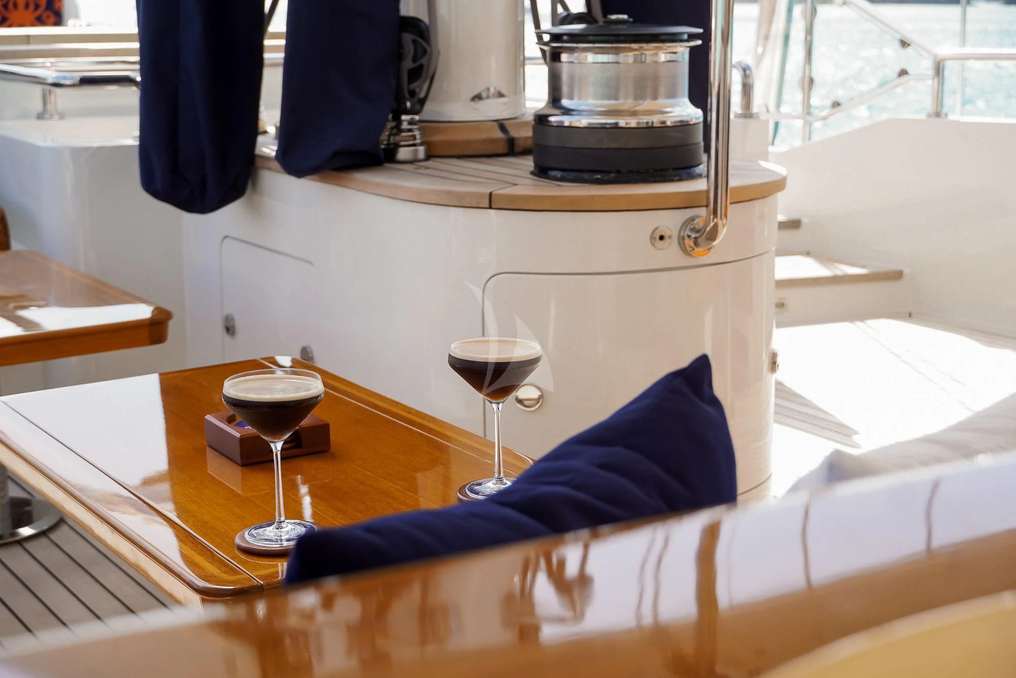 a person sitting at a table with a glass of wine and a book aboard ZENJI Yacht for Sale
