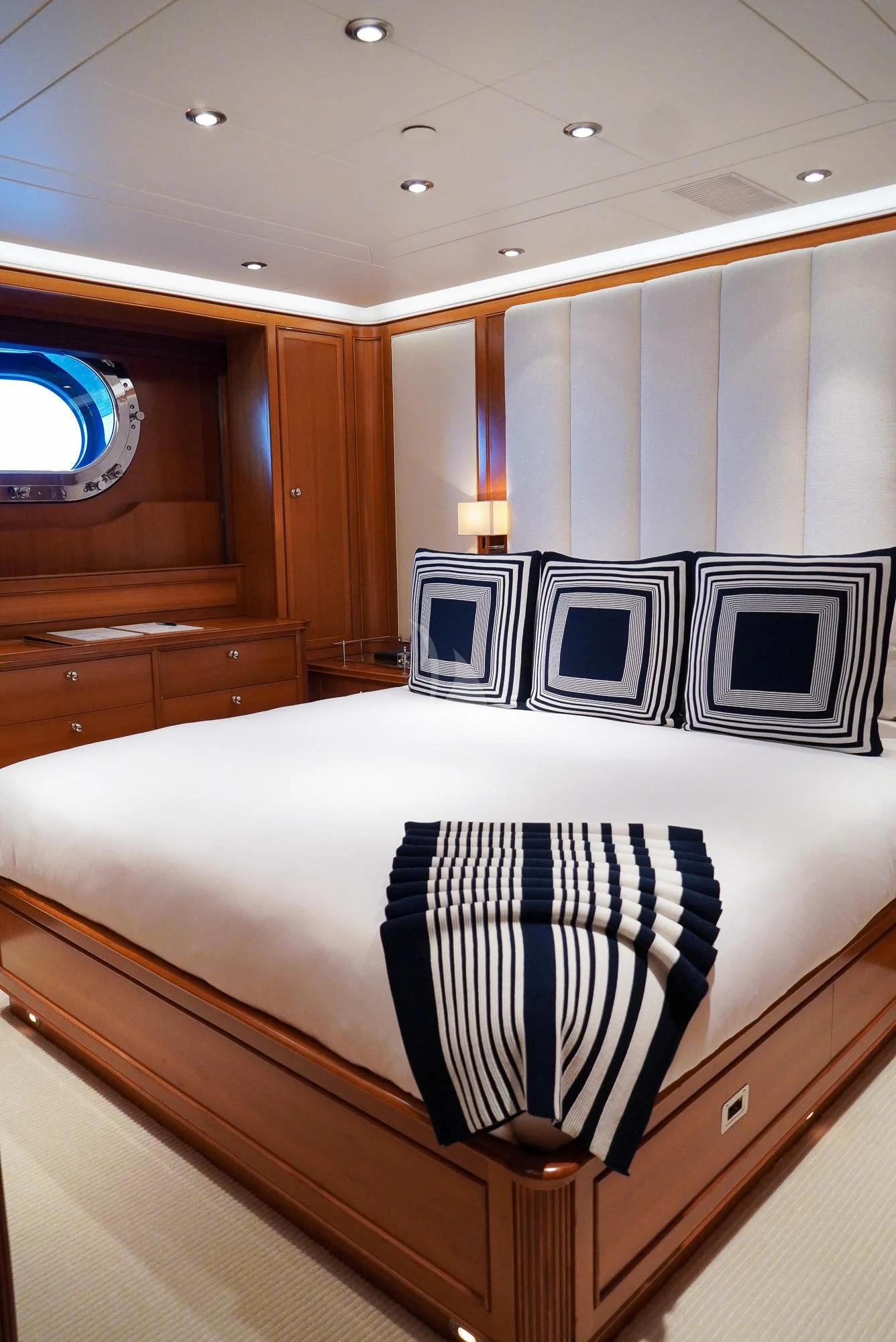a bed with blue and white sheets aboard ZENJI Yacht for Sale