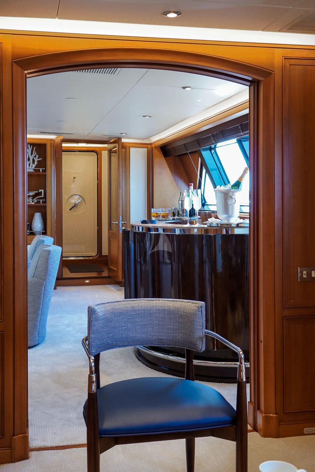 a room with a bar and chairs aboard ZENJI Yacht for Sale