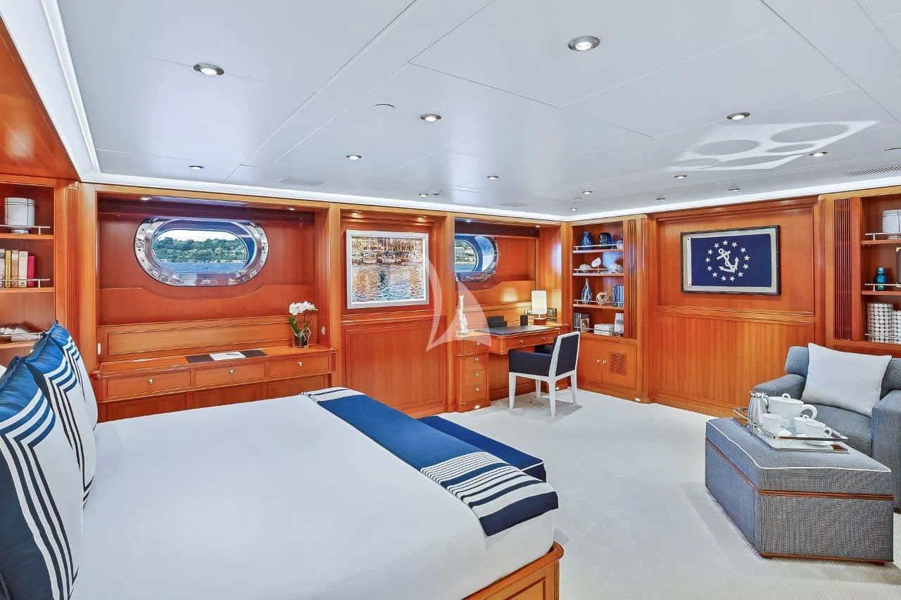 a room with a bed and a couch aboard ZENJI Yacht for Sale