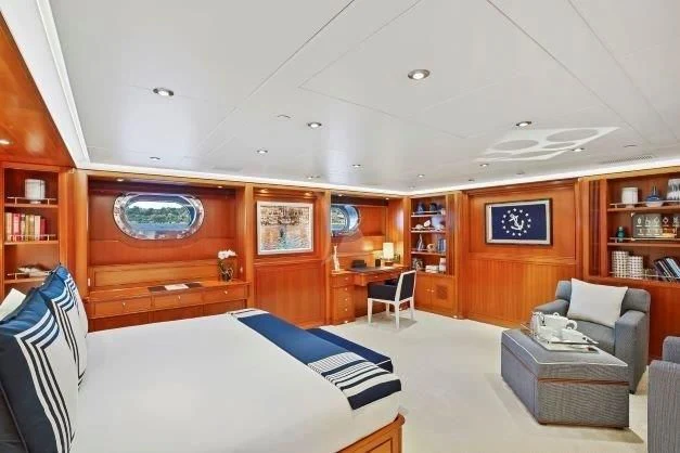 a room with a bed and a couch aboard ZENJI Yacht for Sale