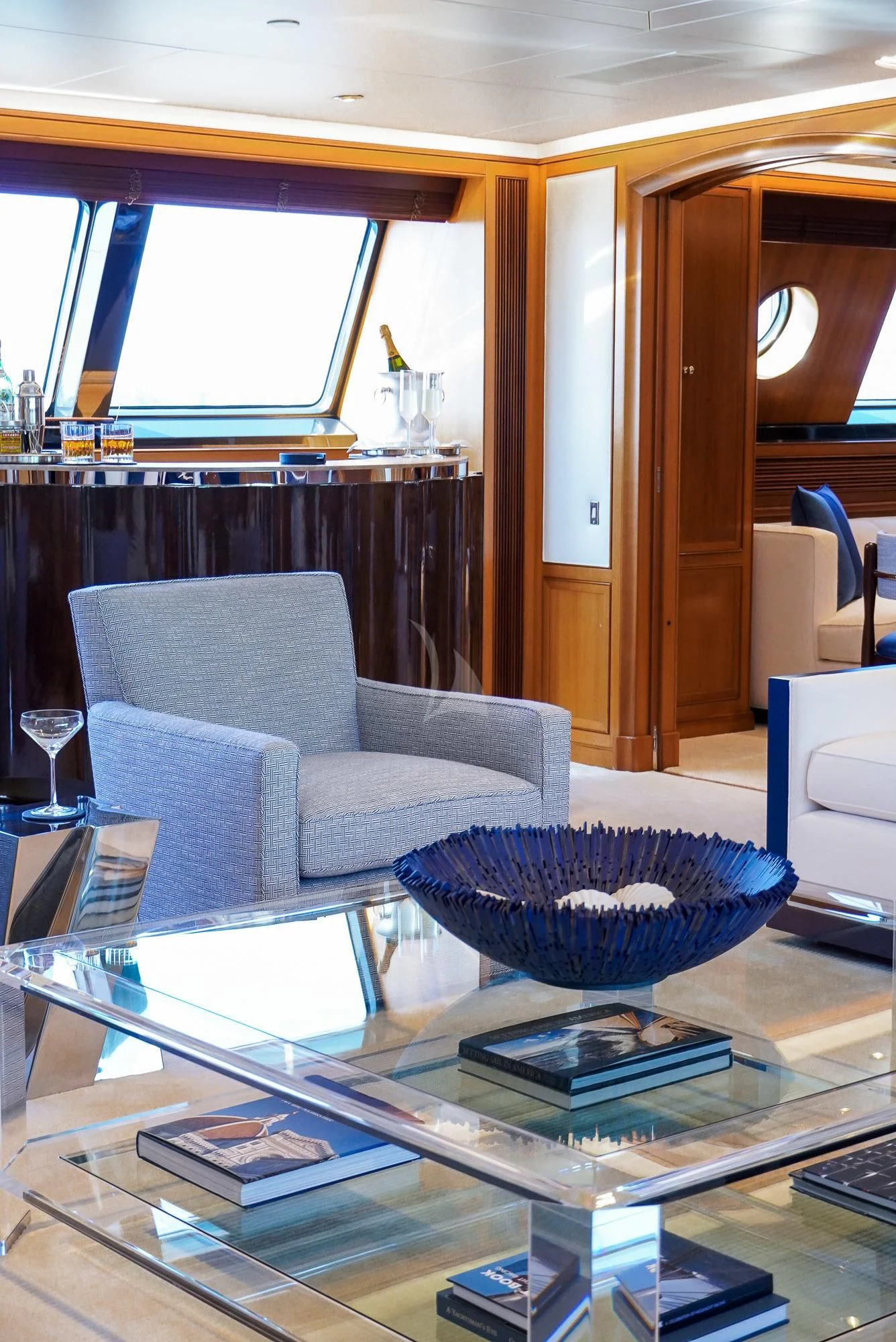 a living room with a glass table aboard ZENJI Yacht for Sale