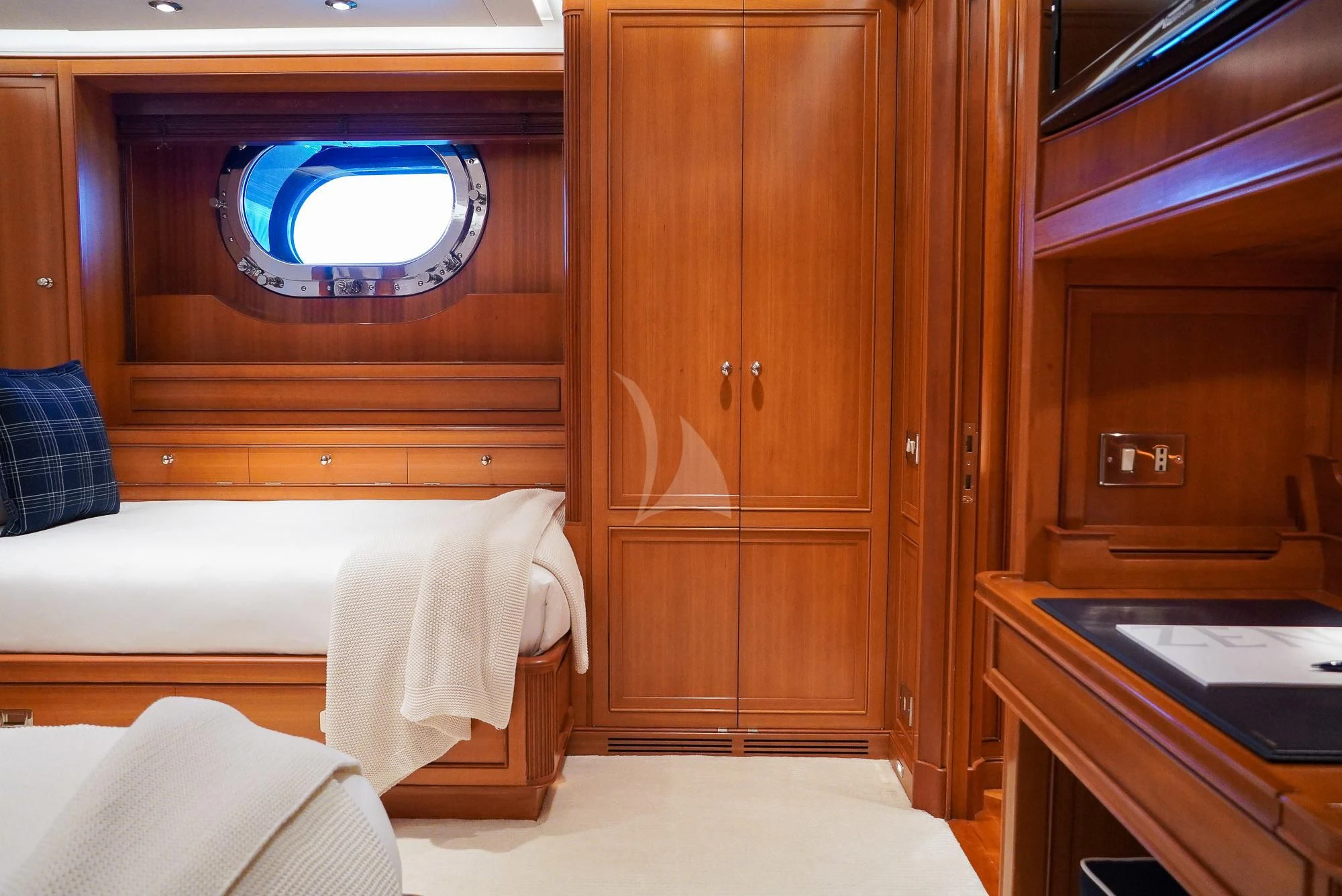 a room with a bed and a desk aboard ZENJI Yacht for Sale