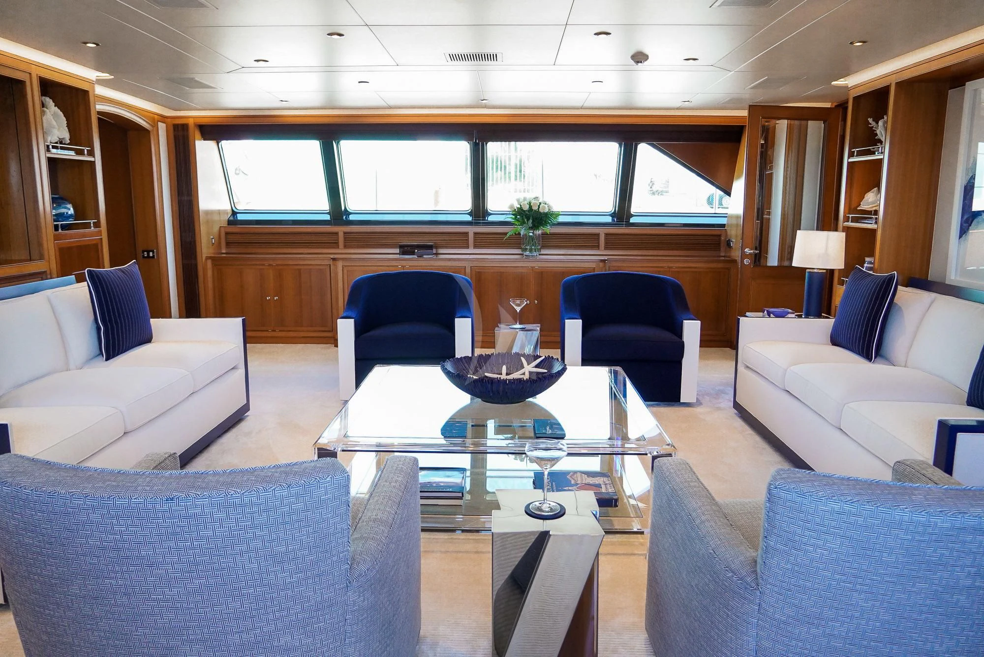 a room with a table chairs and a couch aboard ZENJI Yacht for Sale