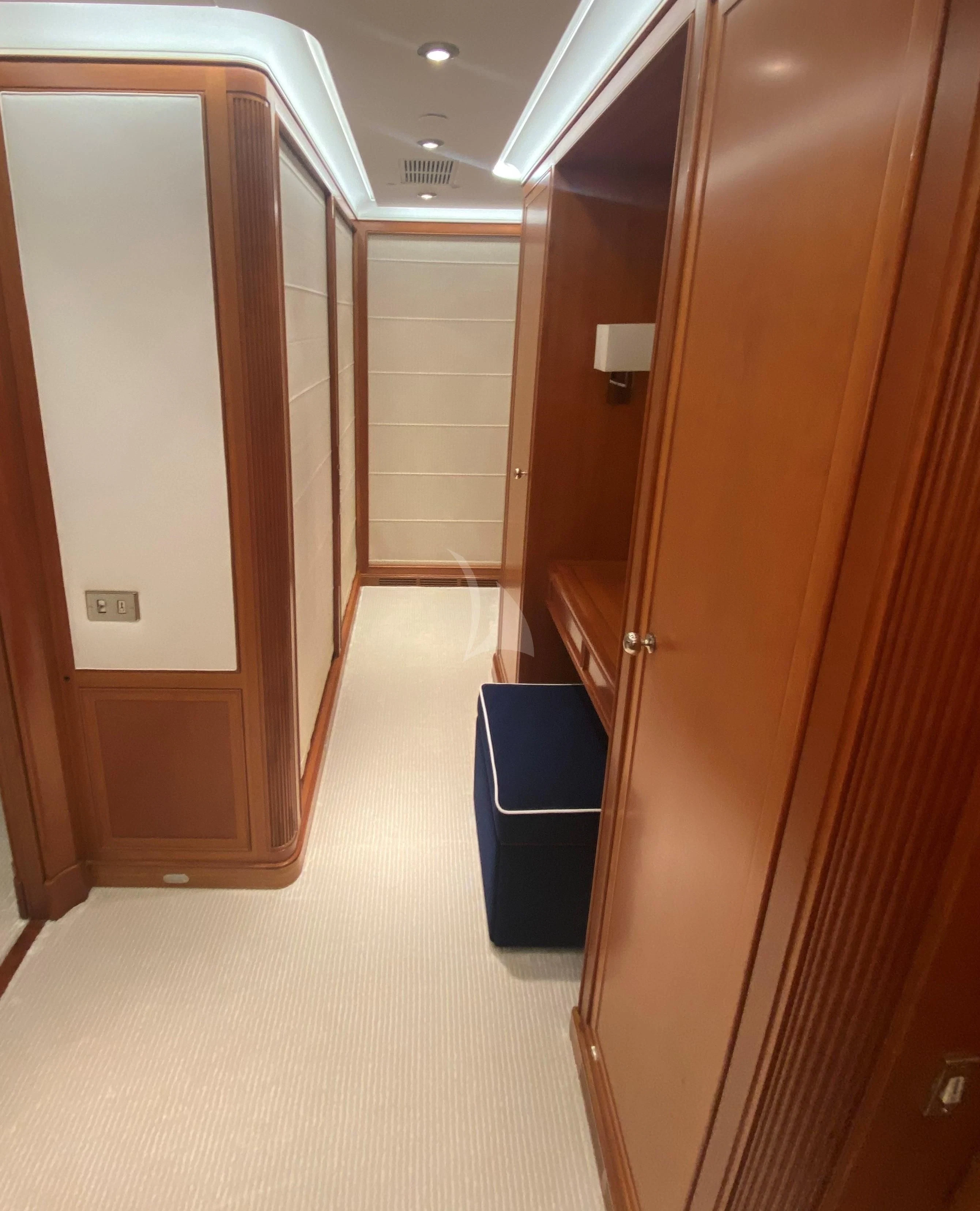 a hallway with a door and a blue trash can aboard ZENJI Yacht for Sale