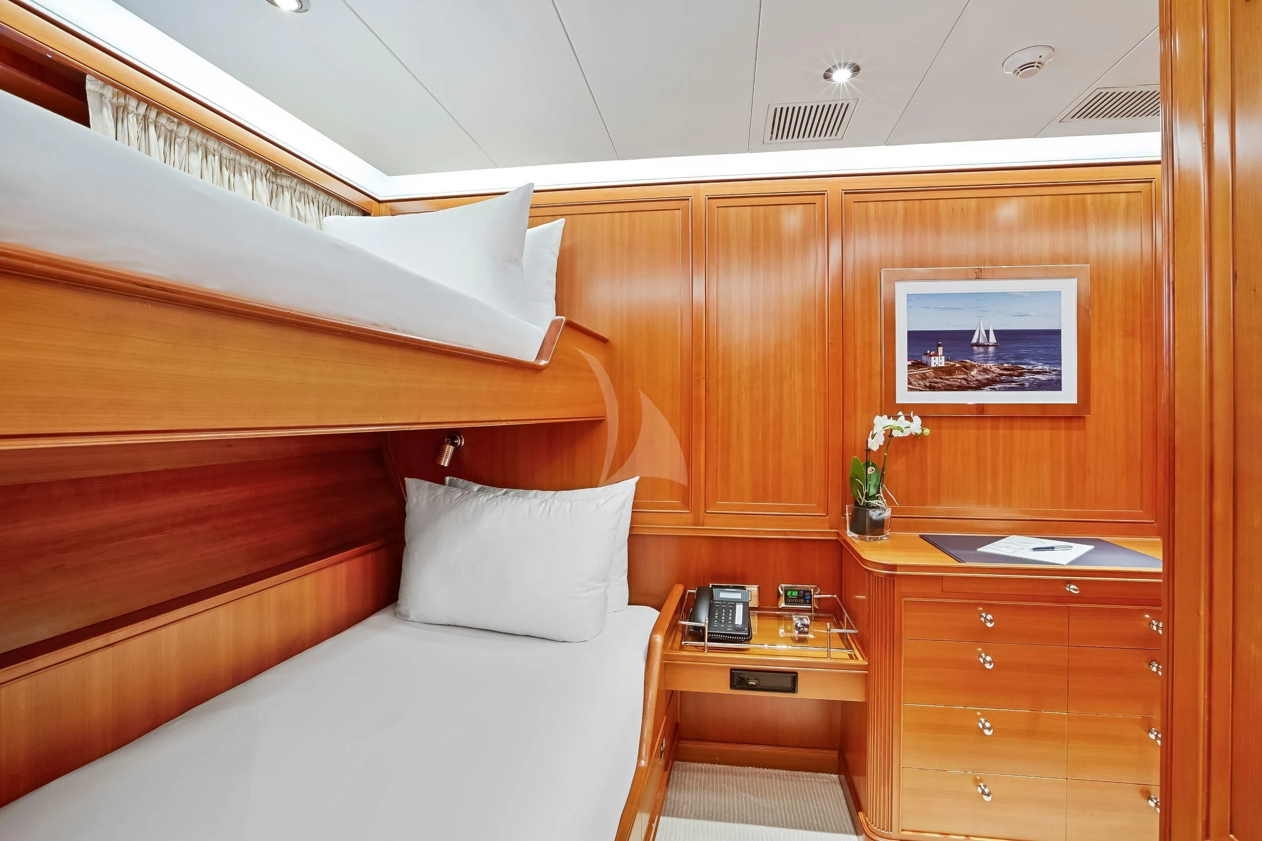 a bed with a desk in a room aboard ZENJI Yacht for Sale
