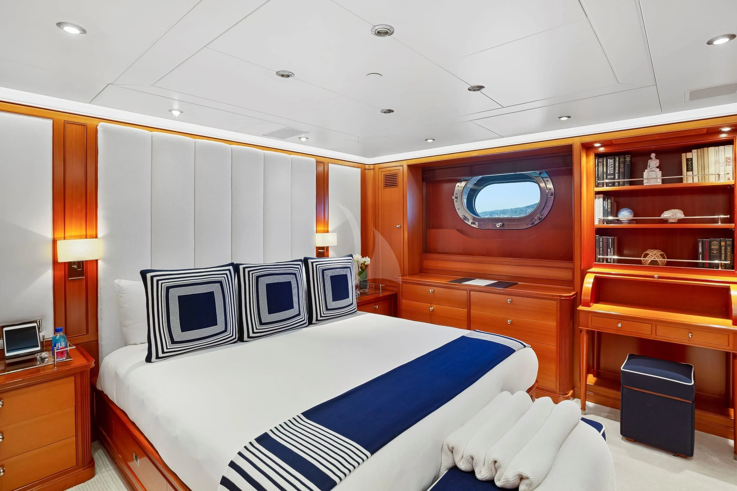 a bedroom with a bed and a desk aboard ZENJI Yacht for Sale