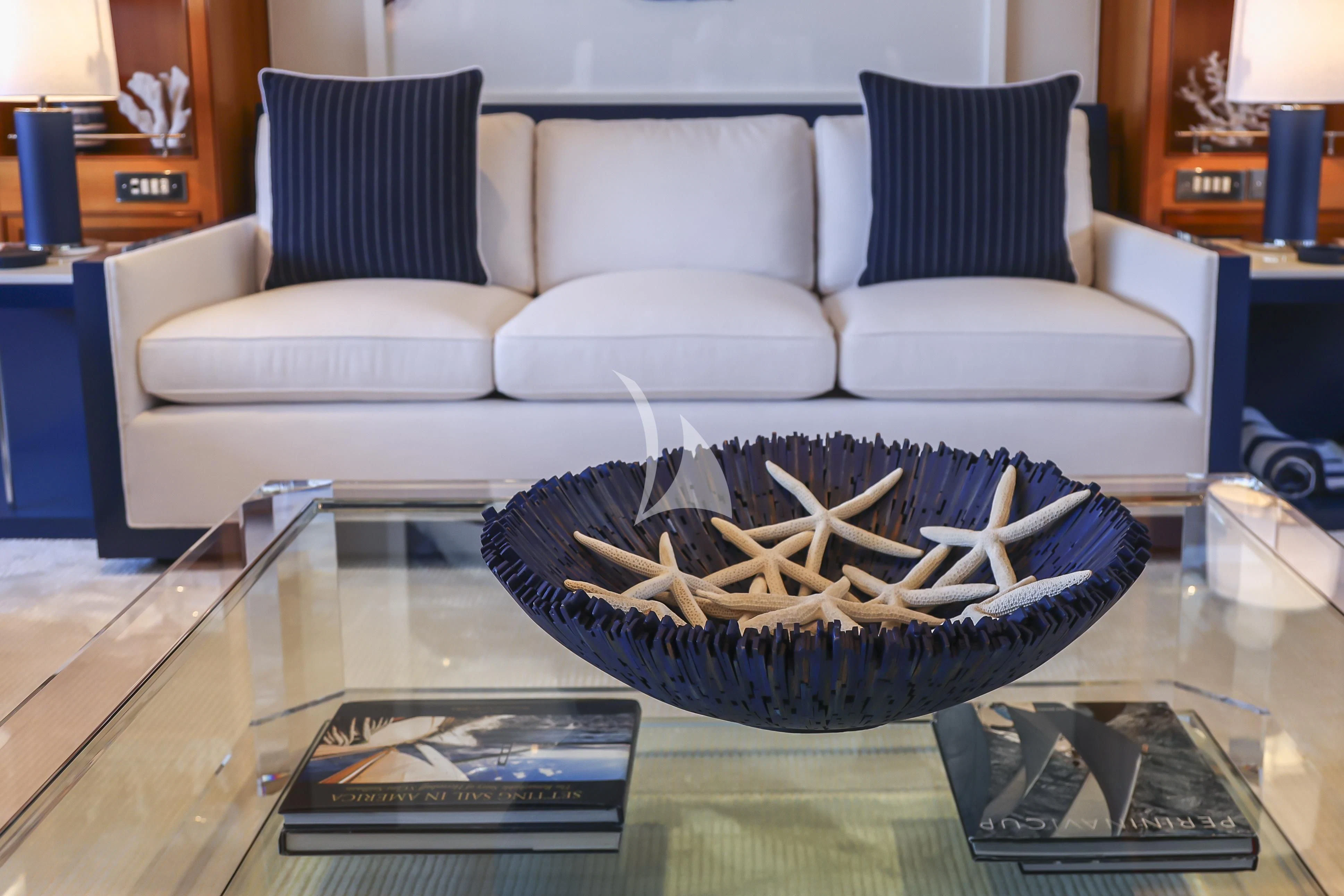 a living room with a large bowl of flowers on a table aboard ZENJI Yacht for Sale