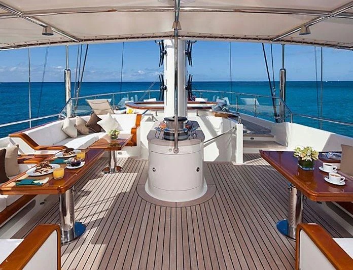 a room with a bed and a table and chairs aboard ZENJI Yacht for Sale