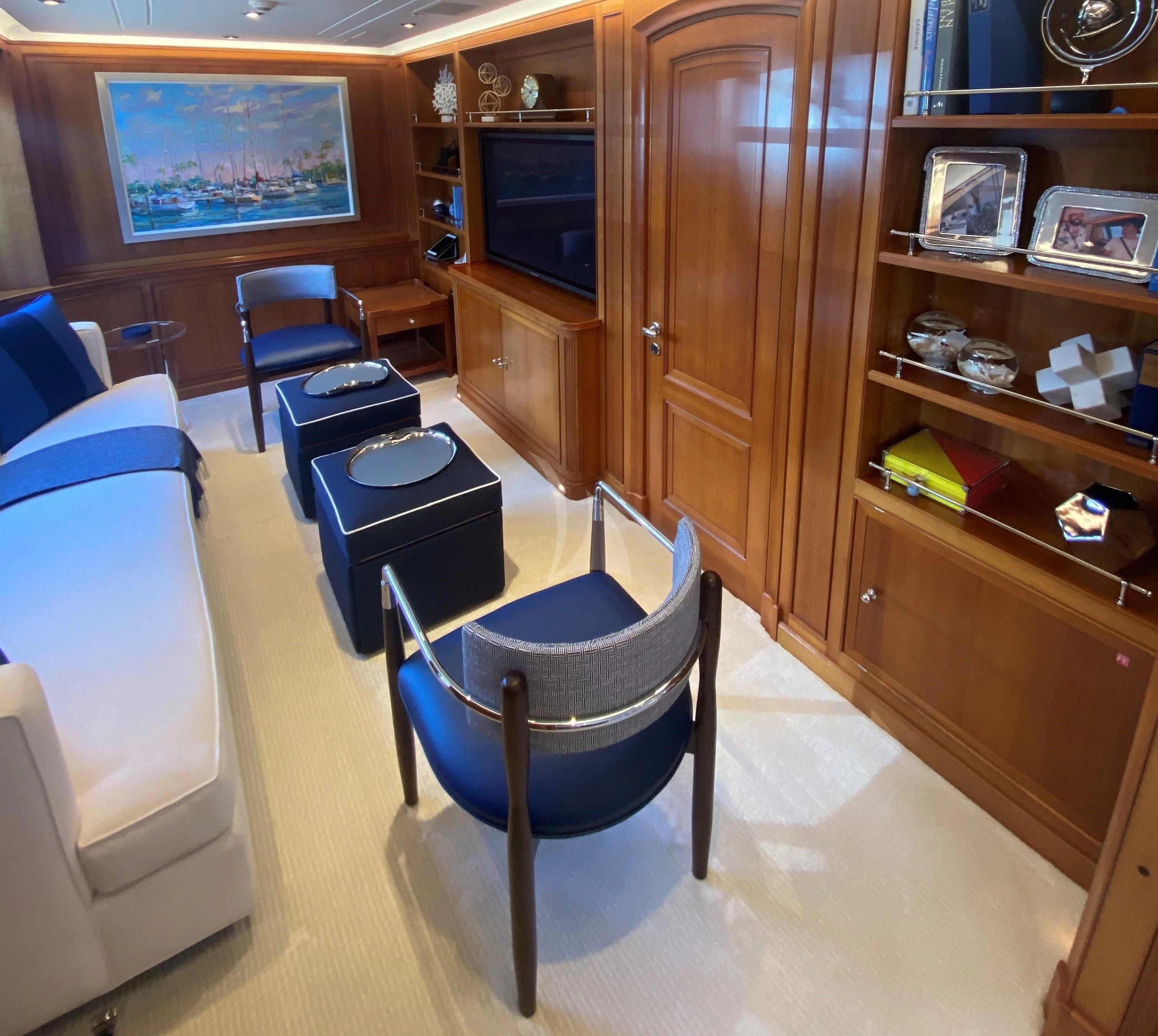 a room with a tv and a shelf with chairs aboard ZENJI Yacht for Sale