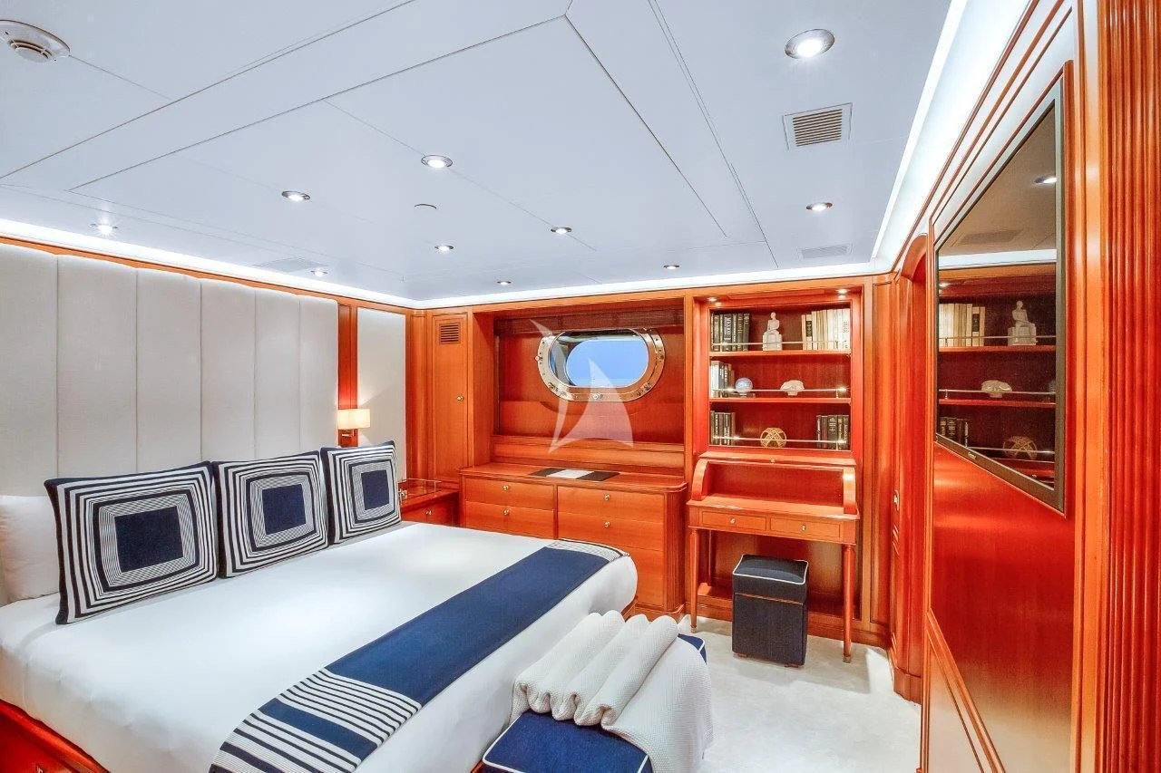 a bedroom with a red wall aboard ZENJI Yacht for Sale
