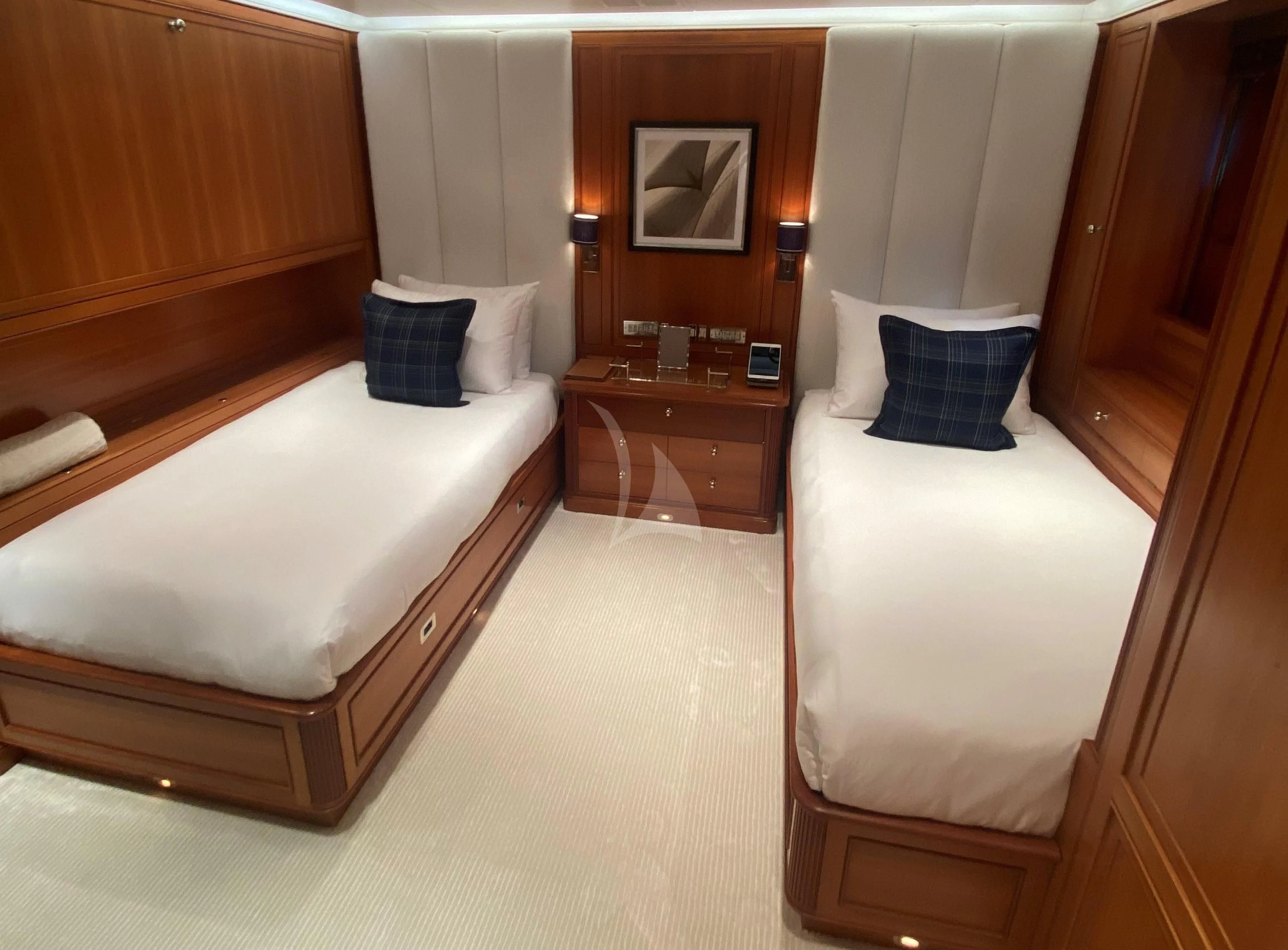 a room with a bed and a dresser aboard ZENJI Yacht for Sale