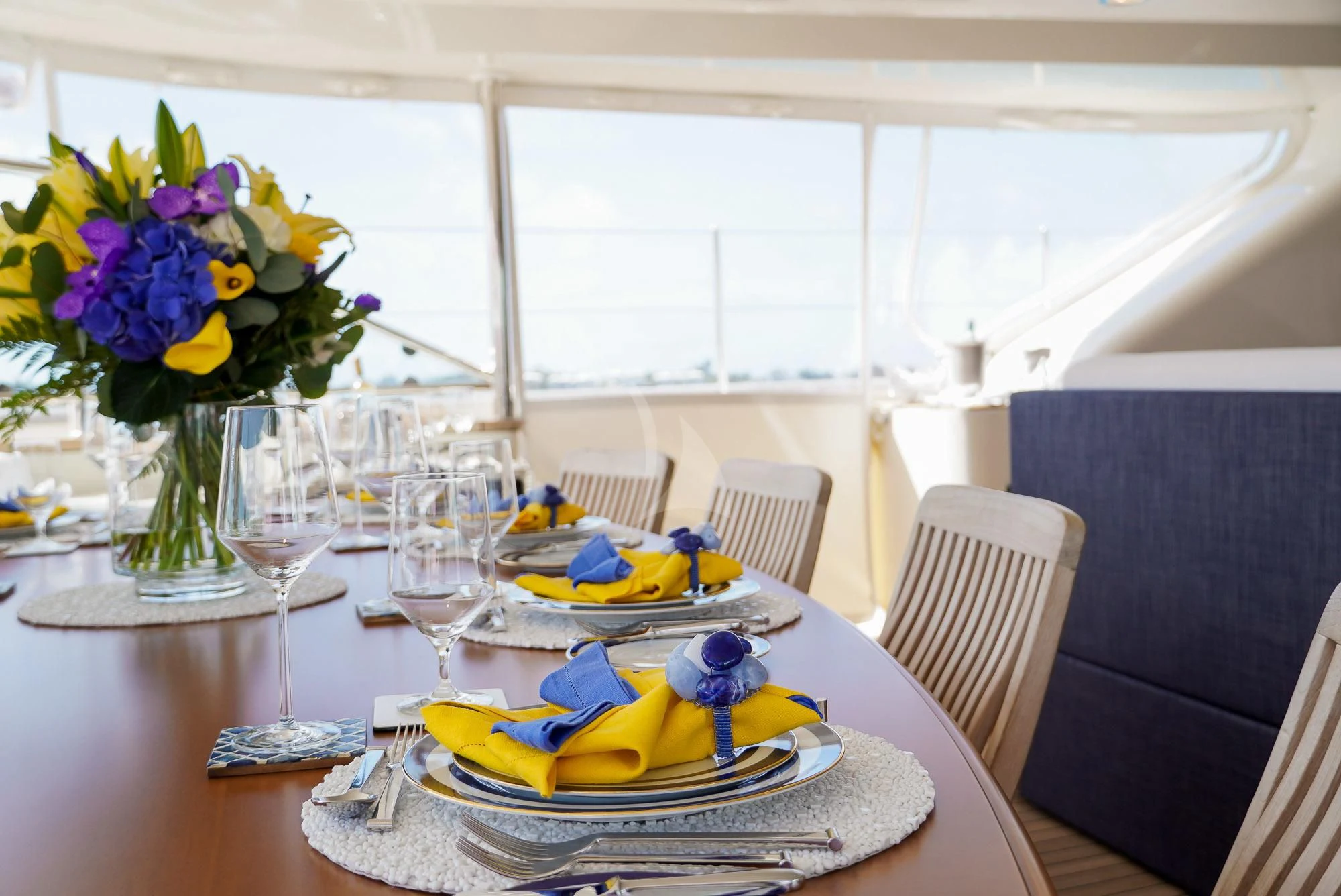 a table with plates and glasses aboard ZENJI Yacht for Sale