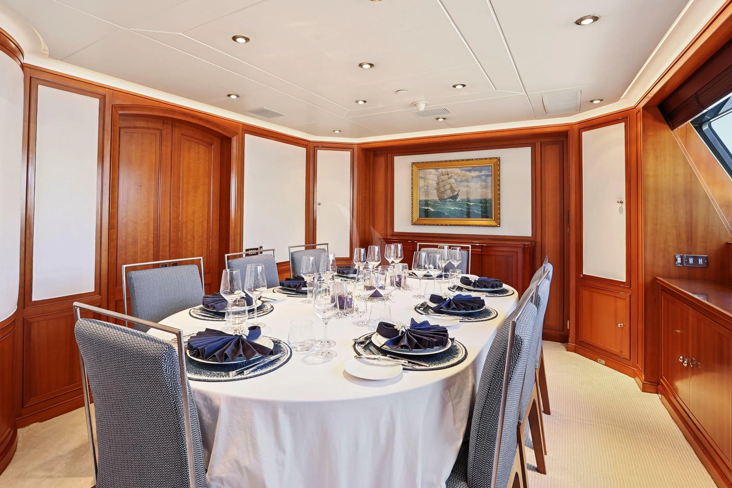 a dining room with a table set aboard ZENJI Yacht for Sale