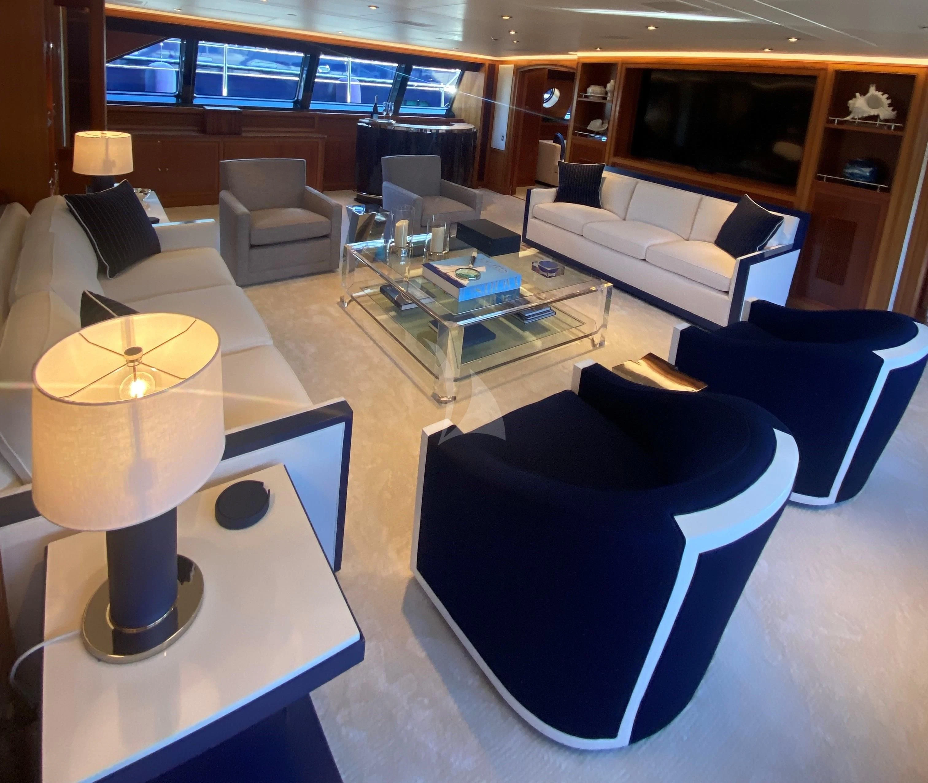 a room with a table and chairs aboard ZENJI Yacht for Sale