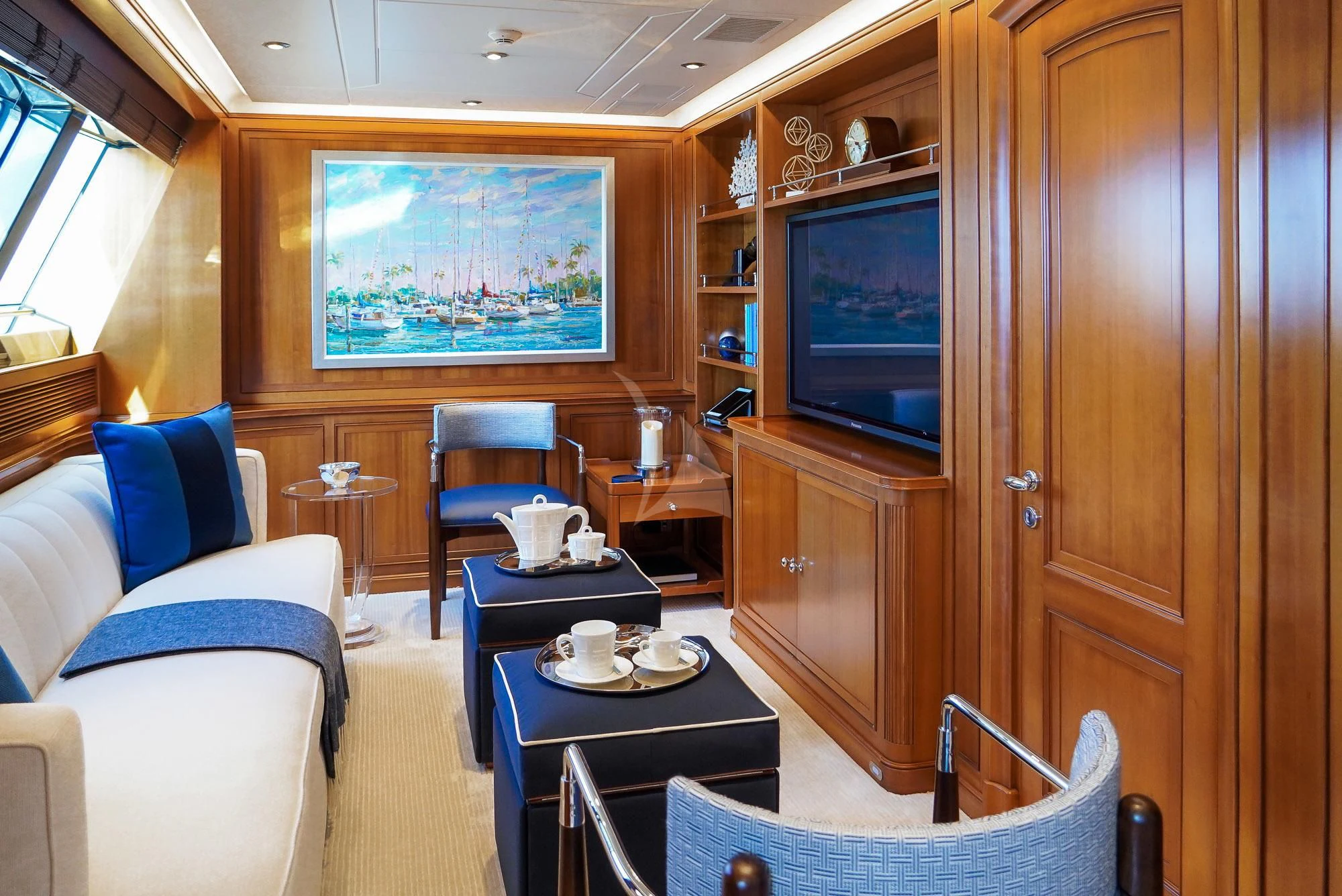a living room with a tv and a table aboard ZENJI Yacht for Sale