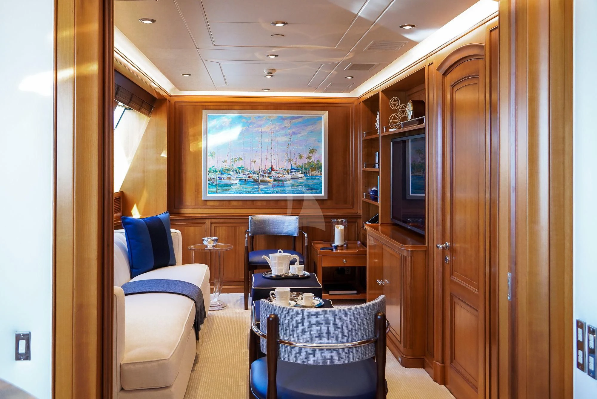 a room with a tv and chairs aboard ZENJI Yacht for Sale