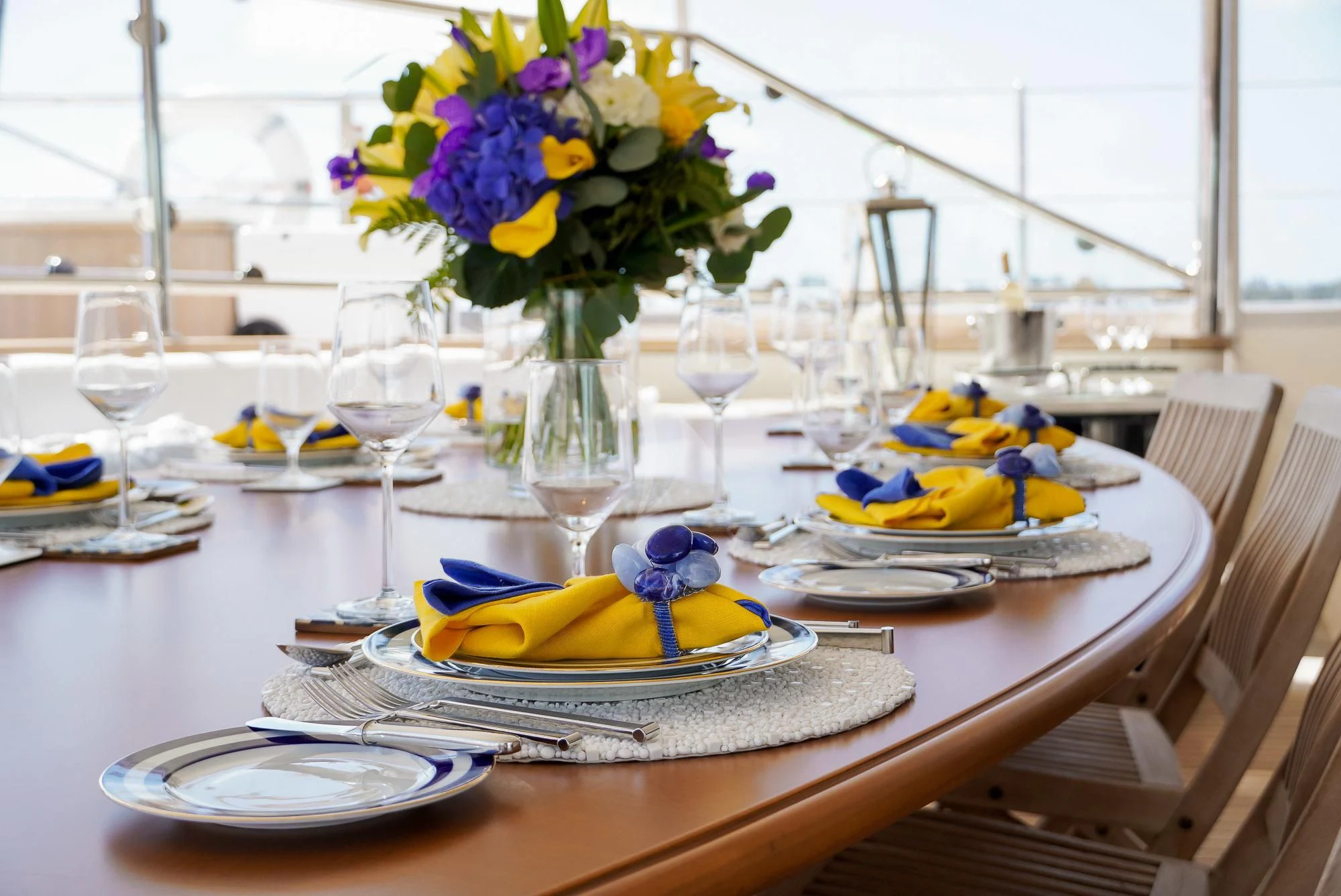 a table with plates and glasses aboard ZENJI Yacht for Sale