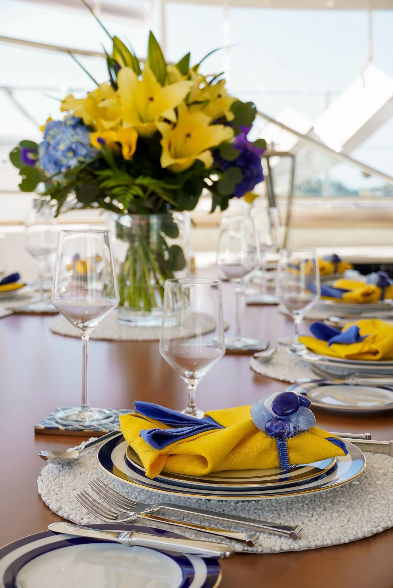a table with plates and glasses aboard ZENJI Yacht for Sale