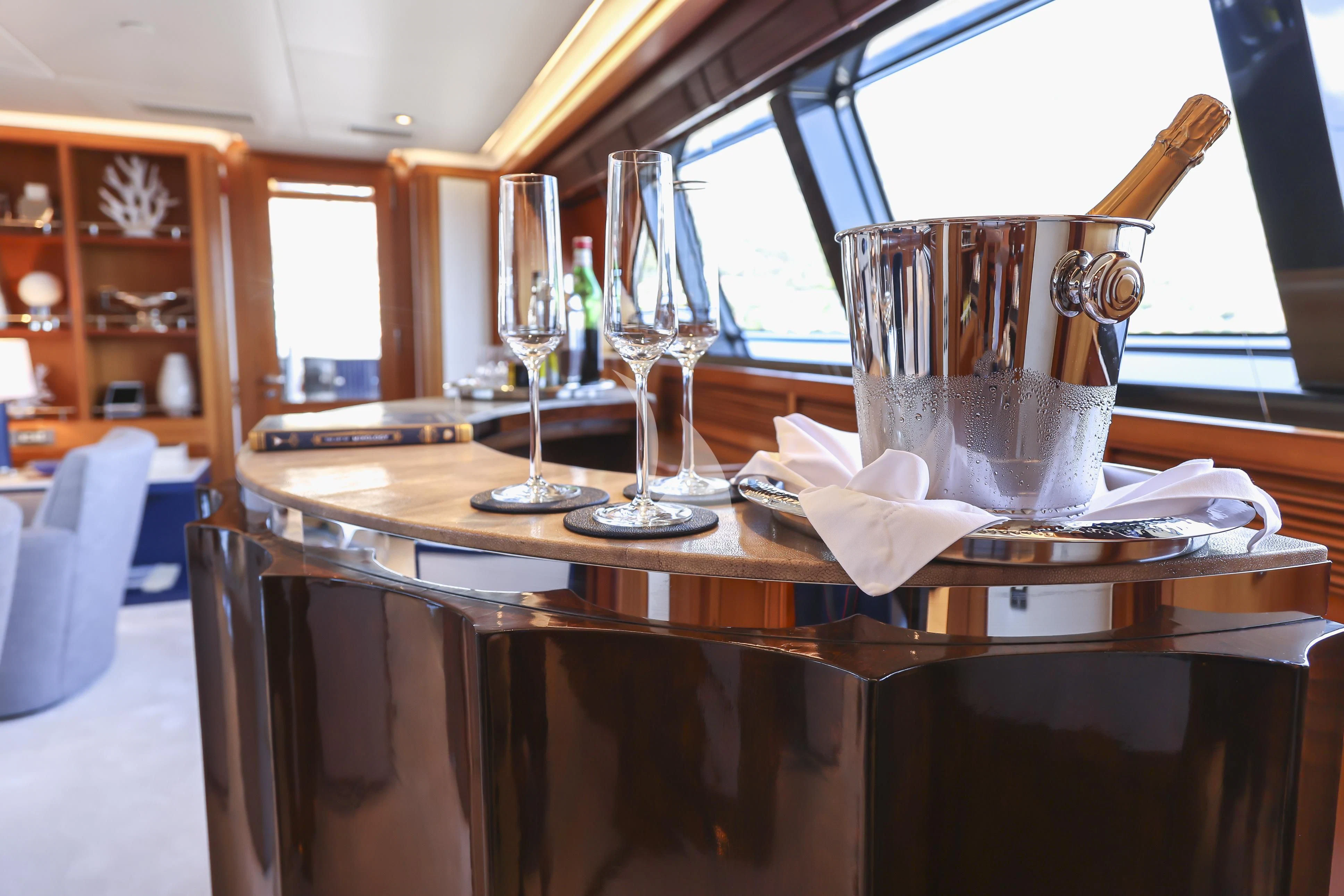 a table with glasses and a plate on it aboard ZENJI Yacht for Sale