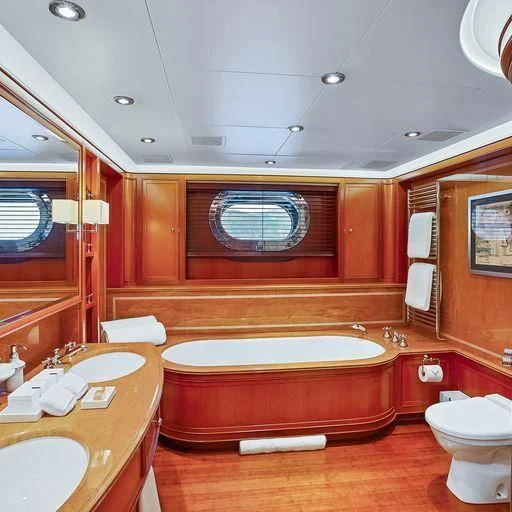 a bathroom with a tub and toilet aboard ZENJI Yacht for Sale