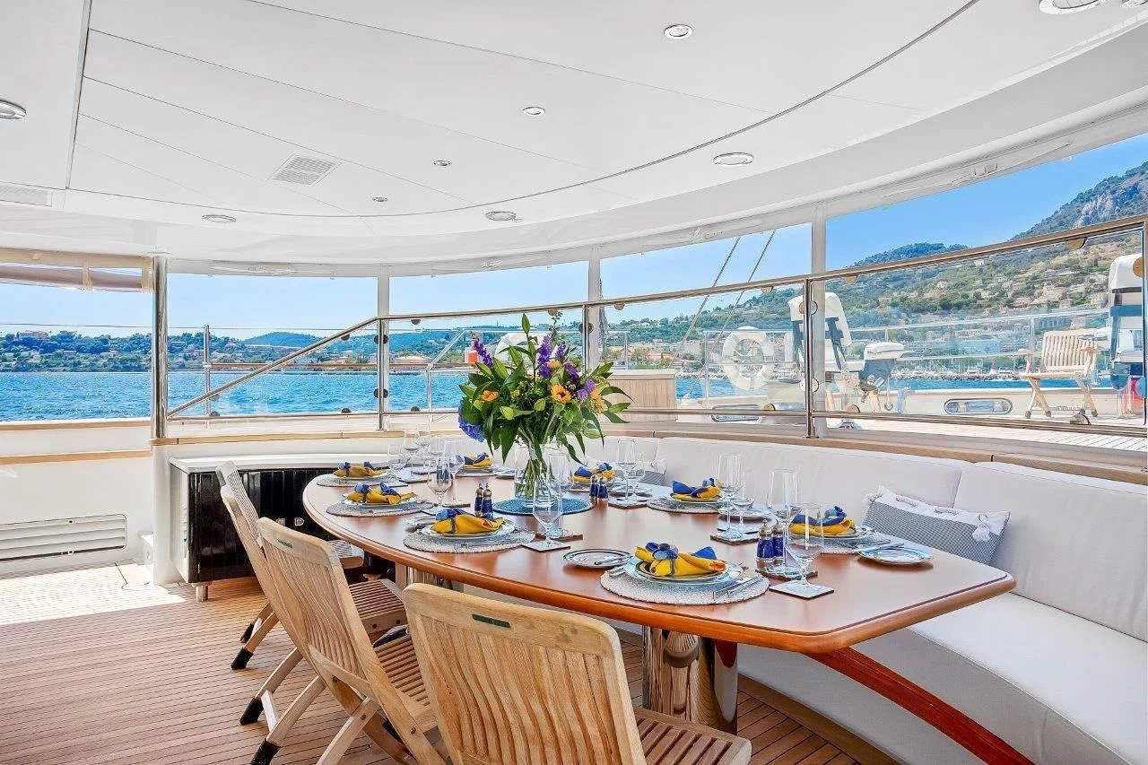 a table with plates and food on it aboard ZENJI Yacht for Sale