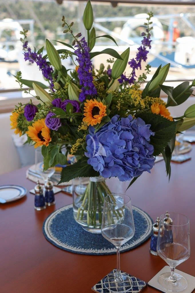 a vase of flowers sits on a table aboard ZENJI Yacht for Sale